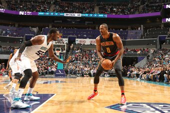 CHARLOTTE, NC - NOVEMBER 18:  Dwight Howard #8 of the Atlanta Hawks handles the ball against Roy Hibbert #55 of the Charlotte Hornets during a game on November 18, 2016 at the Spectrum Center in Charlotte, North Carolina. NOTE TO USER: User expressly ackn