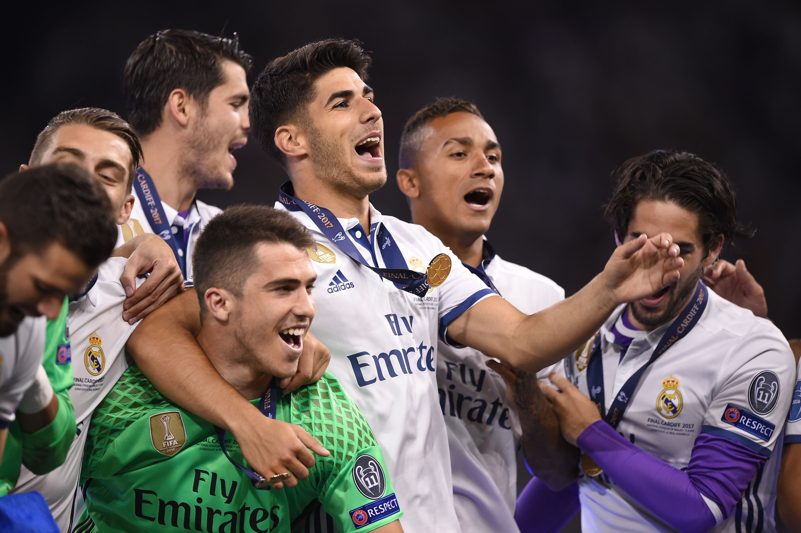 (FromL0 Real Madrid's Spanish goalkeeper Ruben Yanez, Real Madrid's Spanish midfielder Marco Asensio and Real Madrid's Brazilian defender Danilo celebrate with teammates after Real Madrid won the UEFA Champions League final football match between Juventus