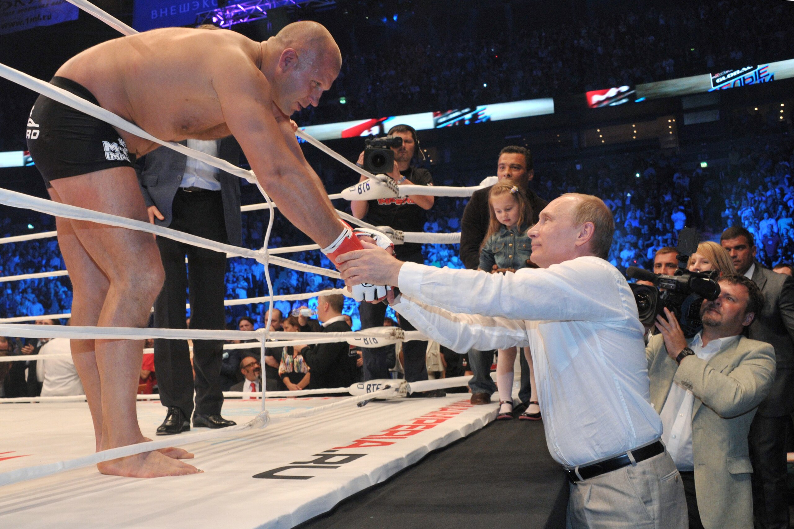 Emelianenko shakes hands with Russian President Vladimir Putin after a recent fight.