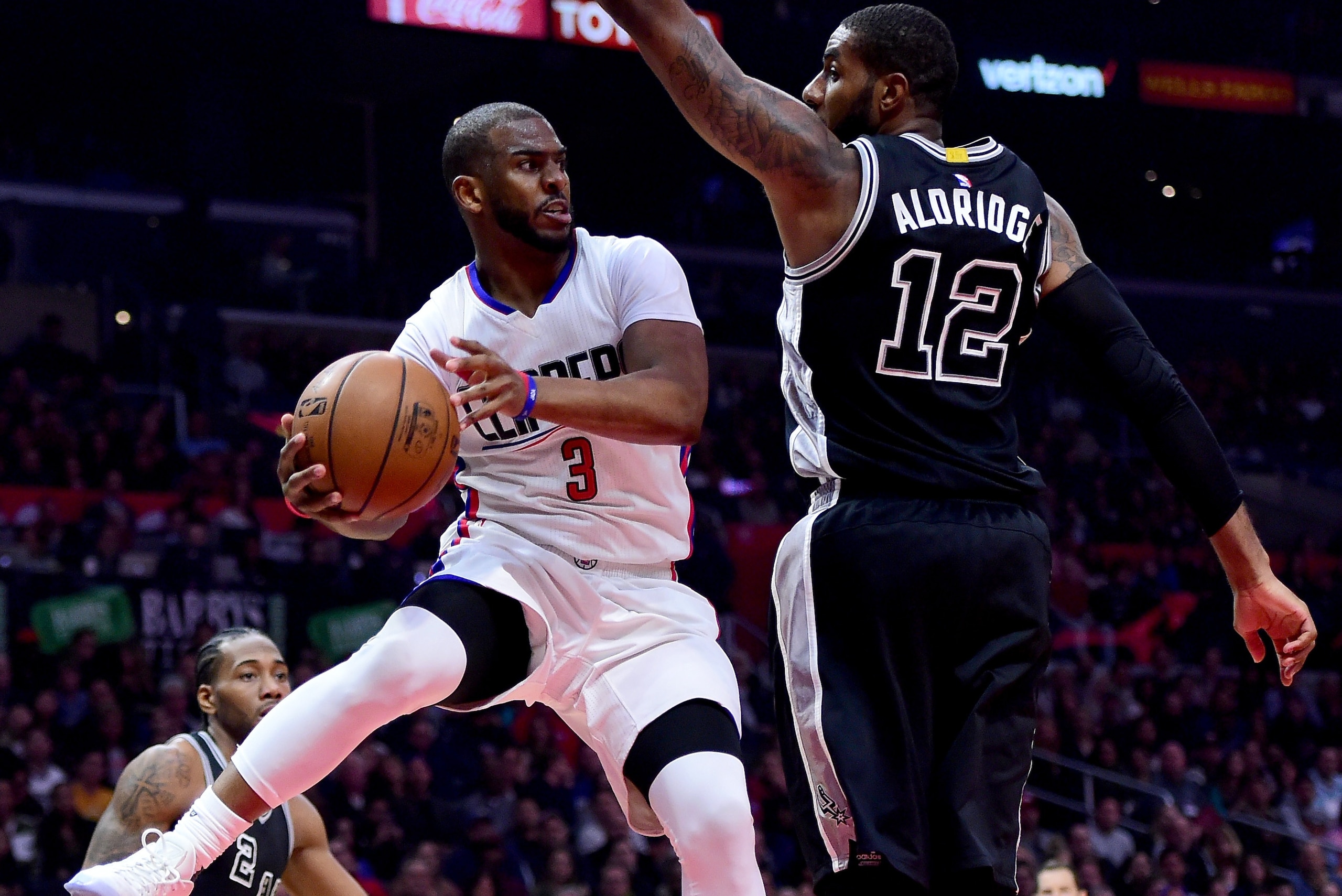 LOS ANGELES, CA - FEBRUARY 24:  Chris Paul #3 of the LA Clippers makes a pass around LaMarcus Aldridge #12 of the San Antonio Spurs during the first half at Staples Center on February 24, 2017 in Los Angeles, California.  NOTE TO USER: User expressly ackn