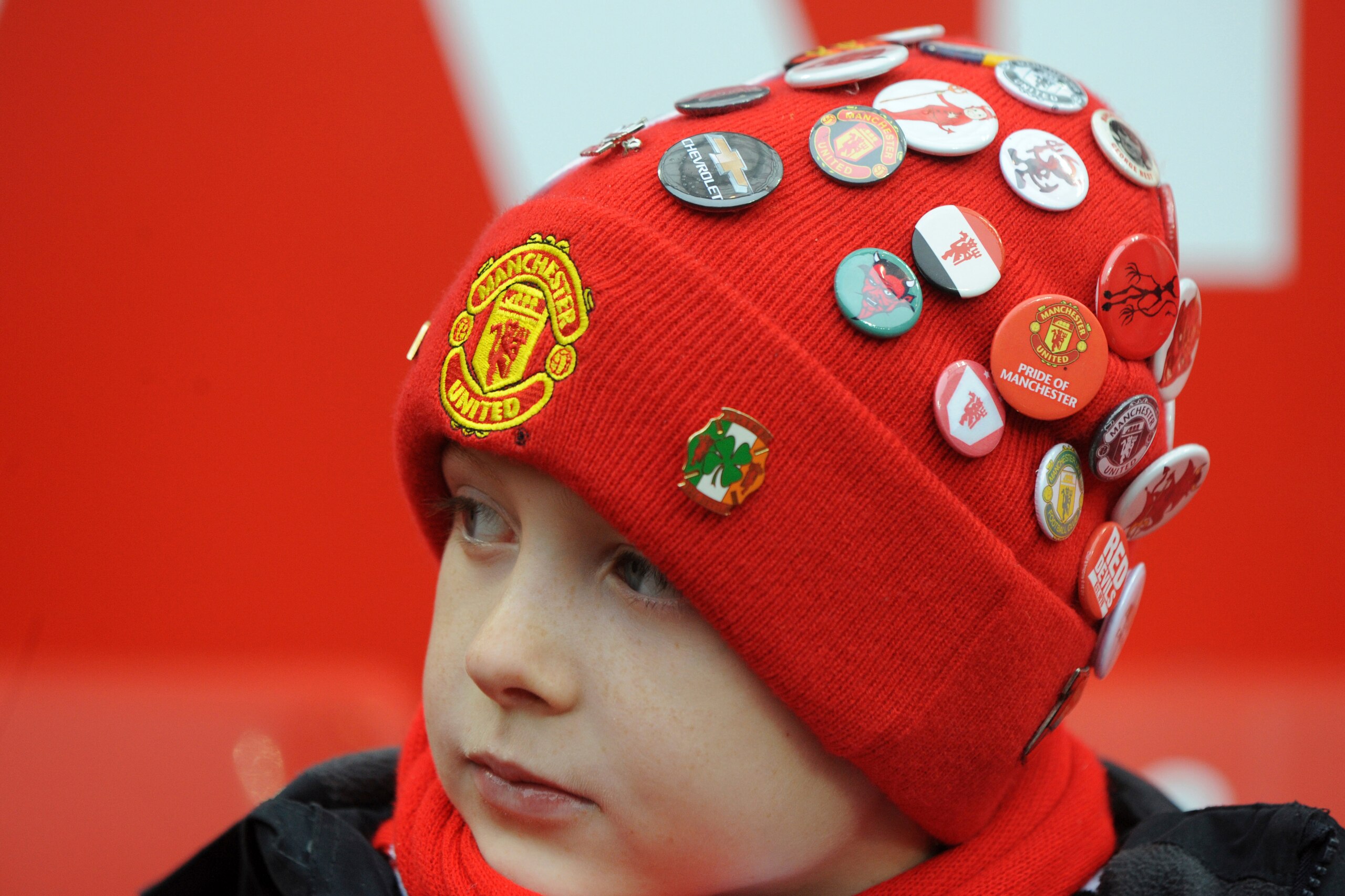 A young United fan shows off his badge collection. A young United fan shows off his badge collection.