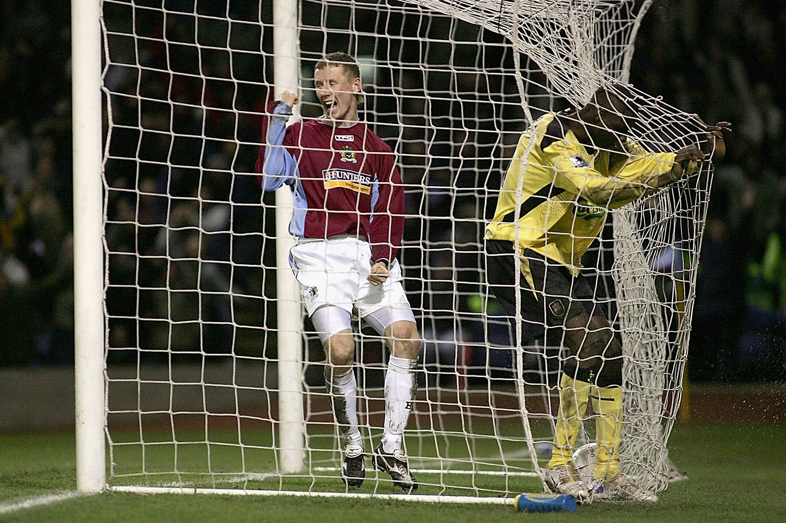 BURNLEY, ENGLAND - JANUARY 18: Lee Roche (left) of Burnley celebrates the own goal scored by Djimi Traore of Liverpool during the FA Cup third round match between Burnley and Liverpool at Turf Moor on January 18, 2005 in Burnley, England.  (Photo by Micha