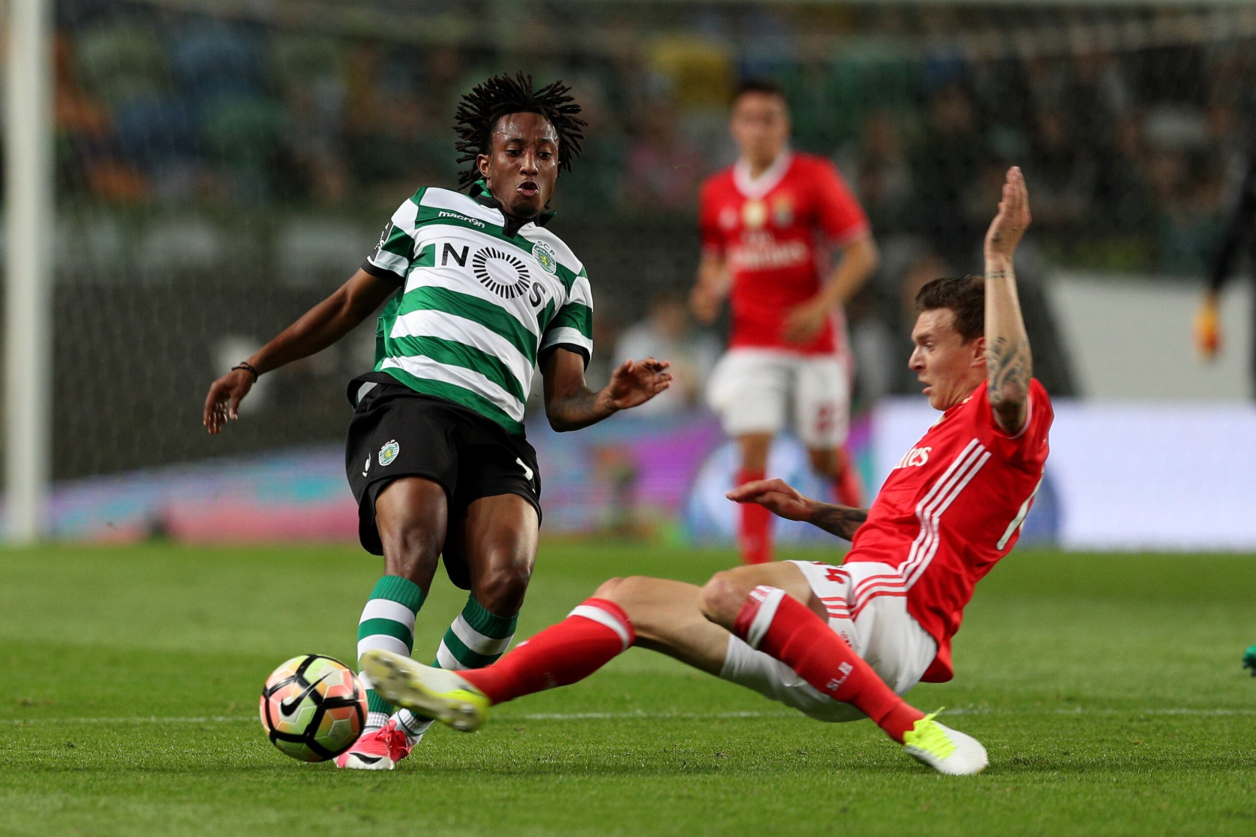 LISBON, PORTUGAL - APRIL 22: Sporting CP's forward Gelson Martins from Portugal (L) tackled by Benfica's defender Victor Nilsson-Lindelof from Sweden (R) during the Sporting CP v SL Benfica - Portuguese Primeira Liga match at Estadio Jose Alvalade on Apri
