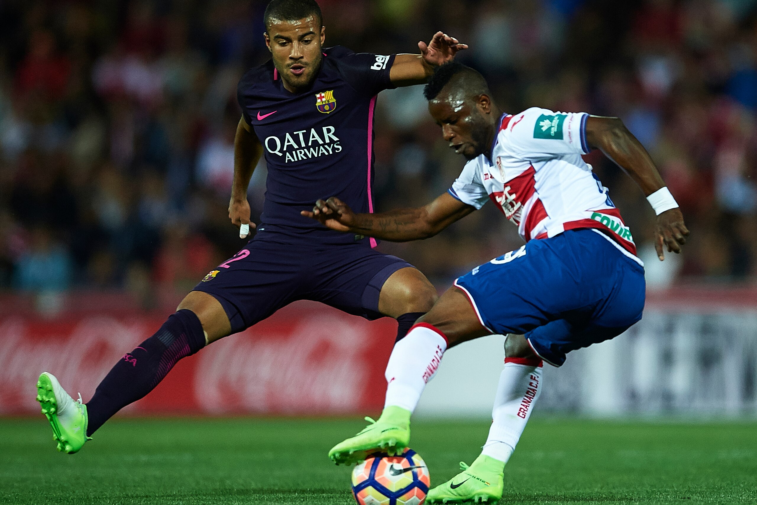 GRANADA, SPAIN - APRIL 02:  Uche Henry Agbo of Granada CF (R) being followed by Rafinha Alcantara of FC Barcelona (L) during the La Liga match between Granada CF v FC Barcelona at Estadio Nuevo Los Carmenes on April 02, 2017 in Granada, Spain.  (Photo by 