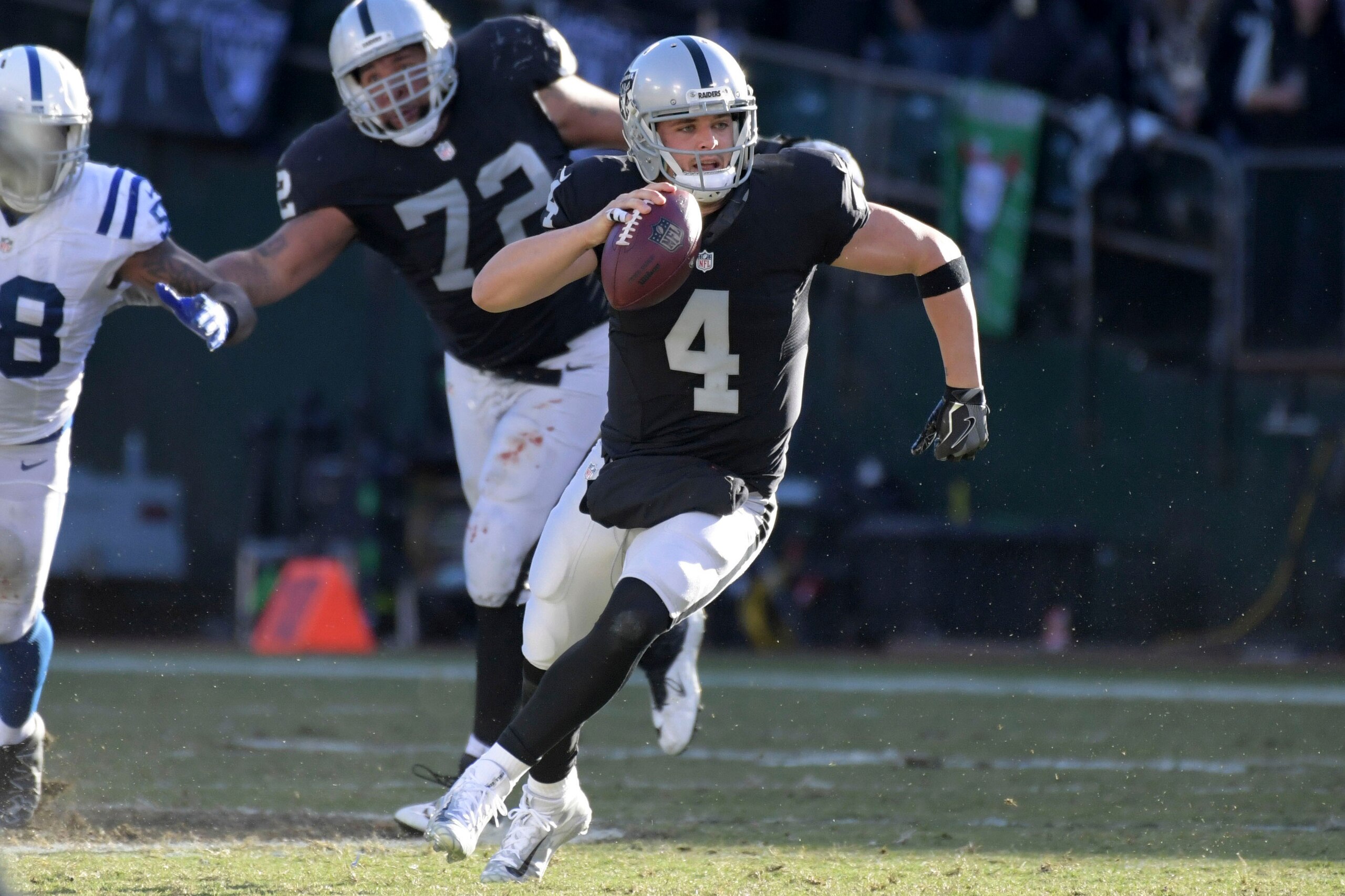Dec 24, 2016; Oakland, CA, USA; Oakland Raiders quarterback Derek Carr (4) carries the ball in the third quarter against the Indianapolis Colts during a NFL football game at Oakland-Alameda County Coliseum. Mandatory Credit: Kirby Lee-USA TODAY Sports