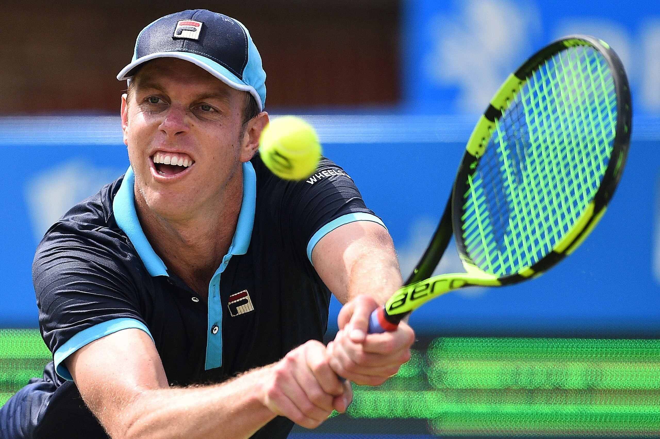 Sam Querrey of the US returns against Australia's Jordan Thompson during their men's singles second round tennis match at the ATP Aegon Championships tennis tournament at Queen's Club in west London on June 22, 2017.
Querrey won 7-6, 3-6, 6-3. / AFP PHOTO