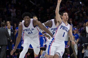 PHILADELPHIA, PA - JANUARY 11: T.J. McConnell #1 of the Philadelphia 76ers celebrates with Joel Embiid #21 and Robert Covington #33 after making the game winning shot at the buzzer against the New York Knicks at the Wells Fargo Center on January 11, 2017 