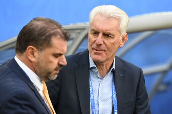 Australia's coach Ange Postecoglou (L) and Cameroon's Belgian coach Hugo Broos stand along the pitch during the 2017 Confederations Cup group B football match between Cameroon and Australia at the Saint Petersburg Stadium on June 22, 2017. / AFP PHOTO / K