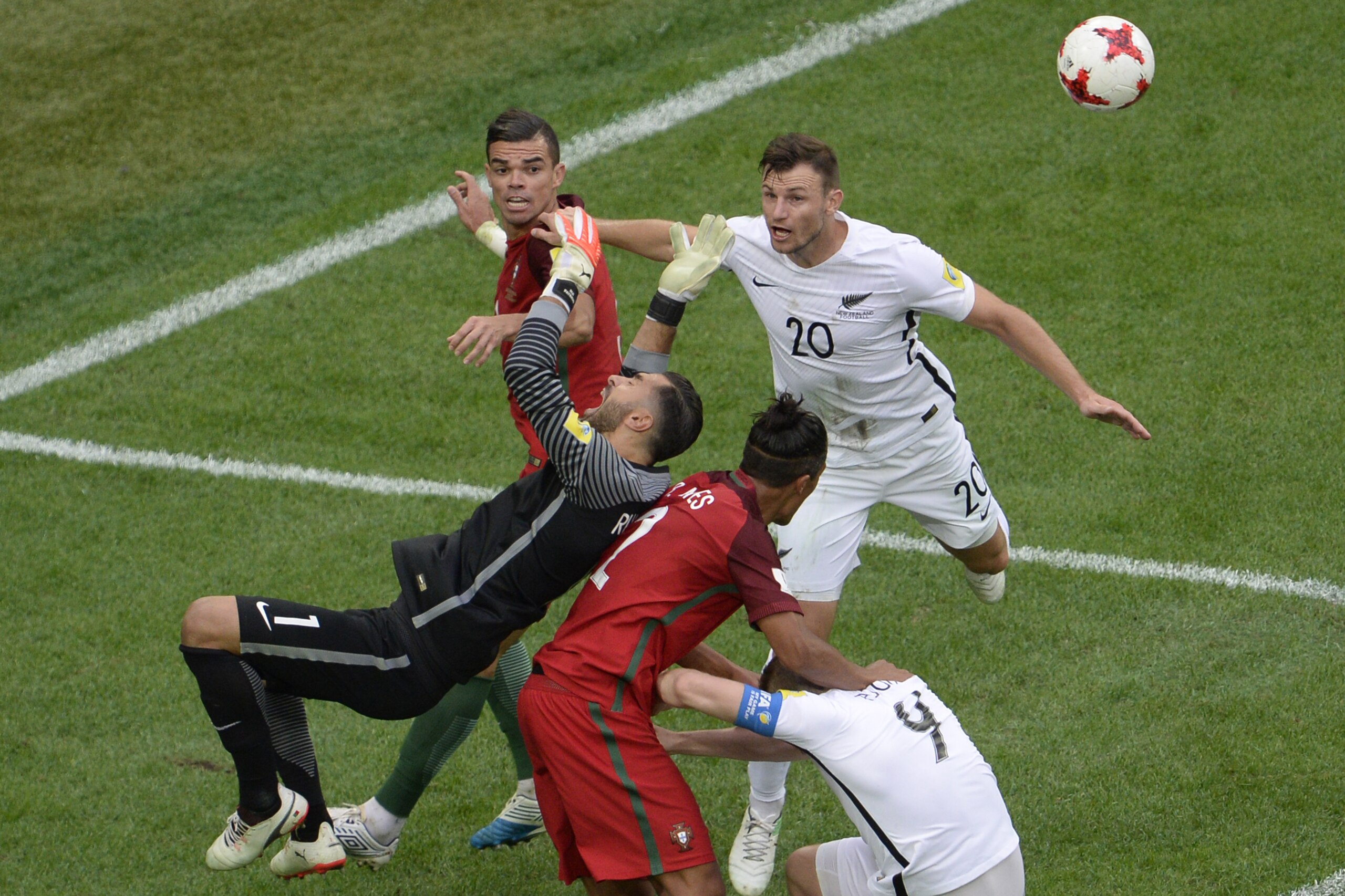 (From L) Portugal's defender Pepe, Portugal's goalkeeper Rui Patricio and Portugal's defender Bruno Alves vie with New Zealand's defender Tommy Smith (R) and New Zealand's forward Chris Wood during the 2017 Confederations Cup group A football match betwee