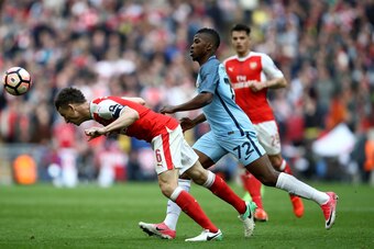 LONDON, ENGLAND - APRIL 23: Laurent Koscielny of Arsenal heads the ball in front of Kelechi Iheanacho of Manchester City during the Emirates FA Cup Semi-Final match between Arsenal and Manchester City at Wembley Stadium on April 23, 2017 in London, Englan