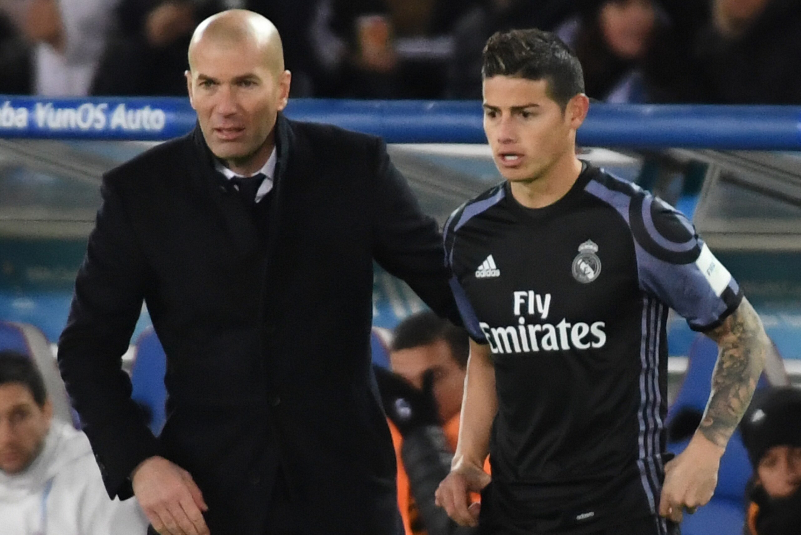YOKOHAMA, JAPAN - DECEMBER 15: Zinedine Zidane,coach (L) and James Rodriguez of Real Madrid look on during the FIFA Club World Cup Semi Final between Club America and Real Madrid at International Stadium Yokohama on December 15, 2016 in Yokohama, Japan. YOKOHAMA, JAPAN - DECEMBER 15: Zinedine Zidane,coach (L) and James Rodriguez of Real Madrid look on during the FIFA Club World Cup Semi Final between Club America and Real Madrid at International Stadium Yokohama on December 15, 2016 in Yokohama, Japan.