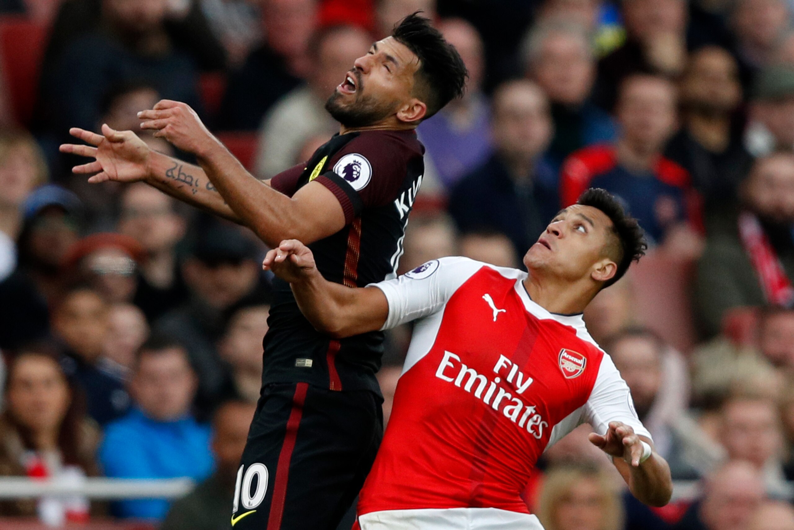 Manchester City's Argentinian striker Sergio Aguero (L) vies with Arsenal's Chilean striker Alexis Sanchez during the English Premier League football match between Arsenal and Manchester City at the Emirates Stadium in London on April 2, 2017. 
The game f