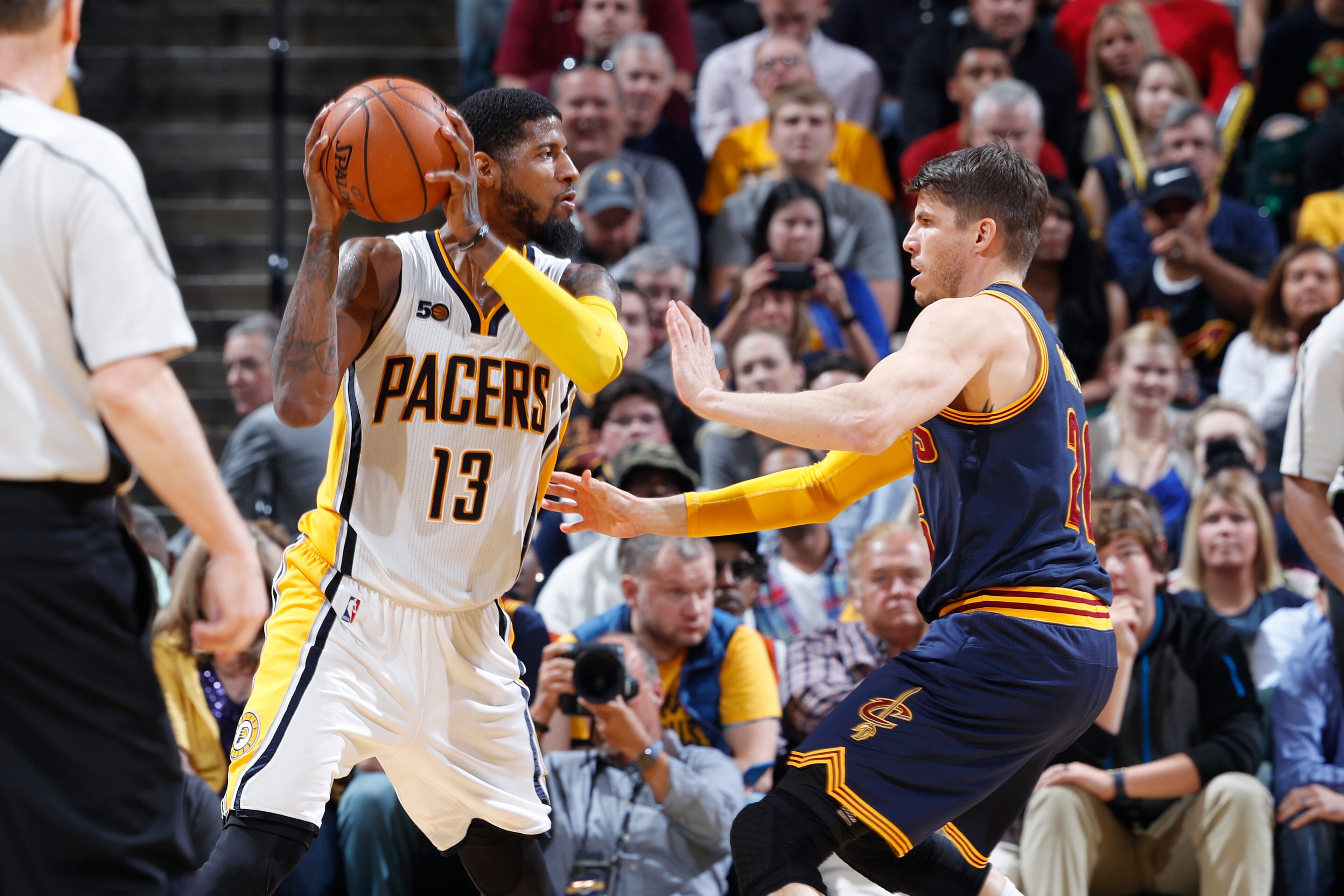 INDIANAPOLIS, IN - APRIL 23: Paul George #13 of the Indiana Pacers handles the ball while defended by Kyle Korver #26 of the Cleveland Cavaliers in Game Four of the Eastern Conference Quarterfinals during the 2017 NBA Playoffs at Bankers Life Fieldhouse o