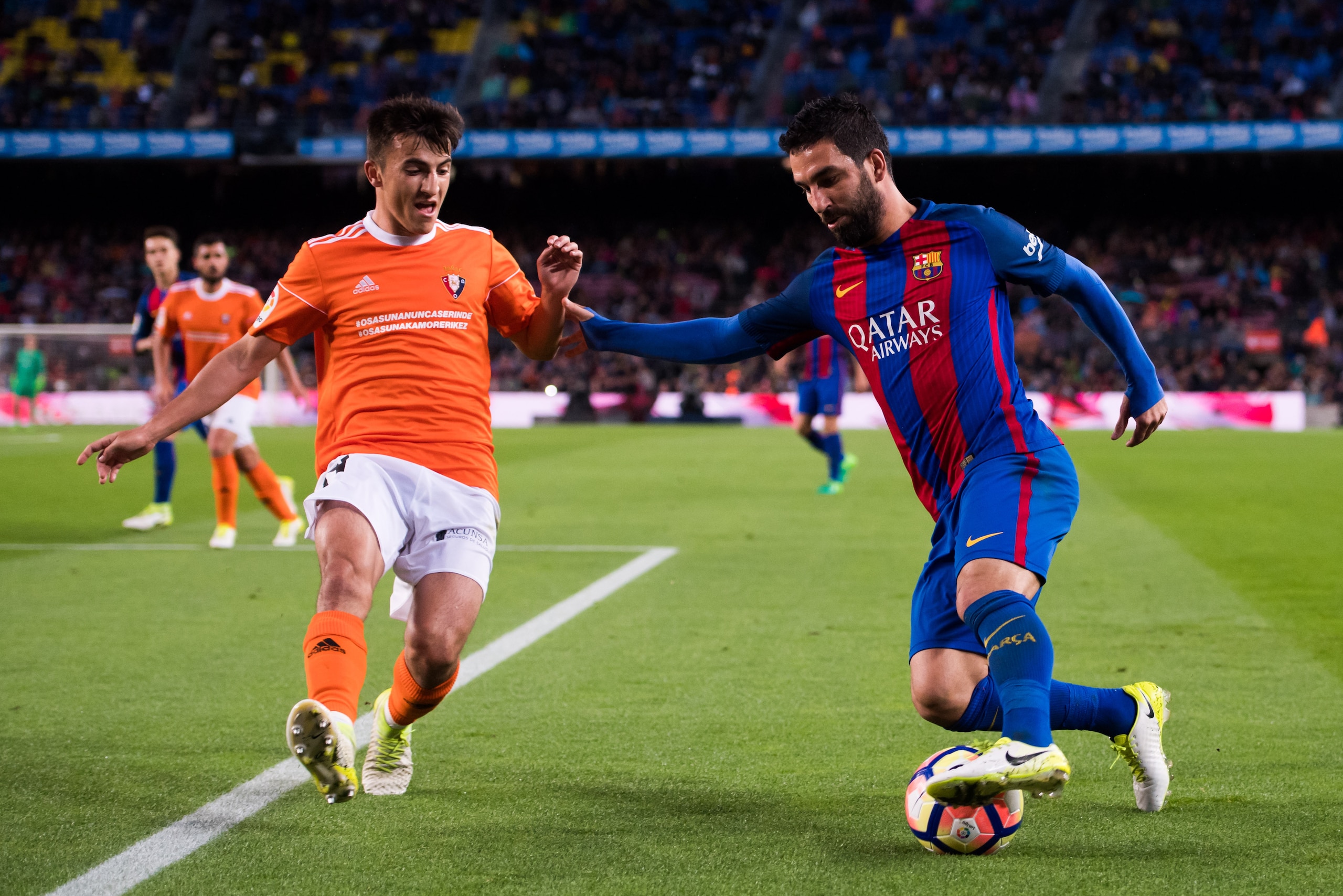 BARCELONA, SPAIN - APRIL 26:  Arda Turan of FC Barcelona dribbles Aitor Bunuel of CA Osasuna during the La Liga match between FC Barcelona and CA Osasuna at Camp Nou stadium on April 26, 2017 in Barcelona, Spain.  (Photo by Alex Caparros/Getty Images)
