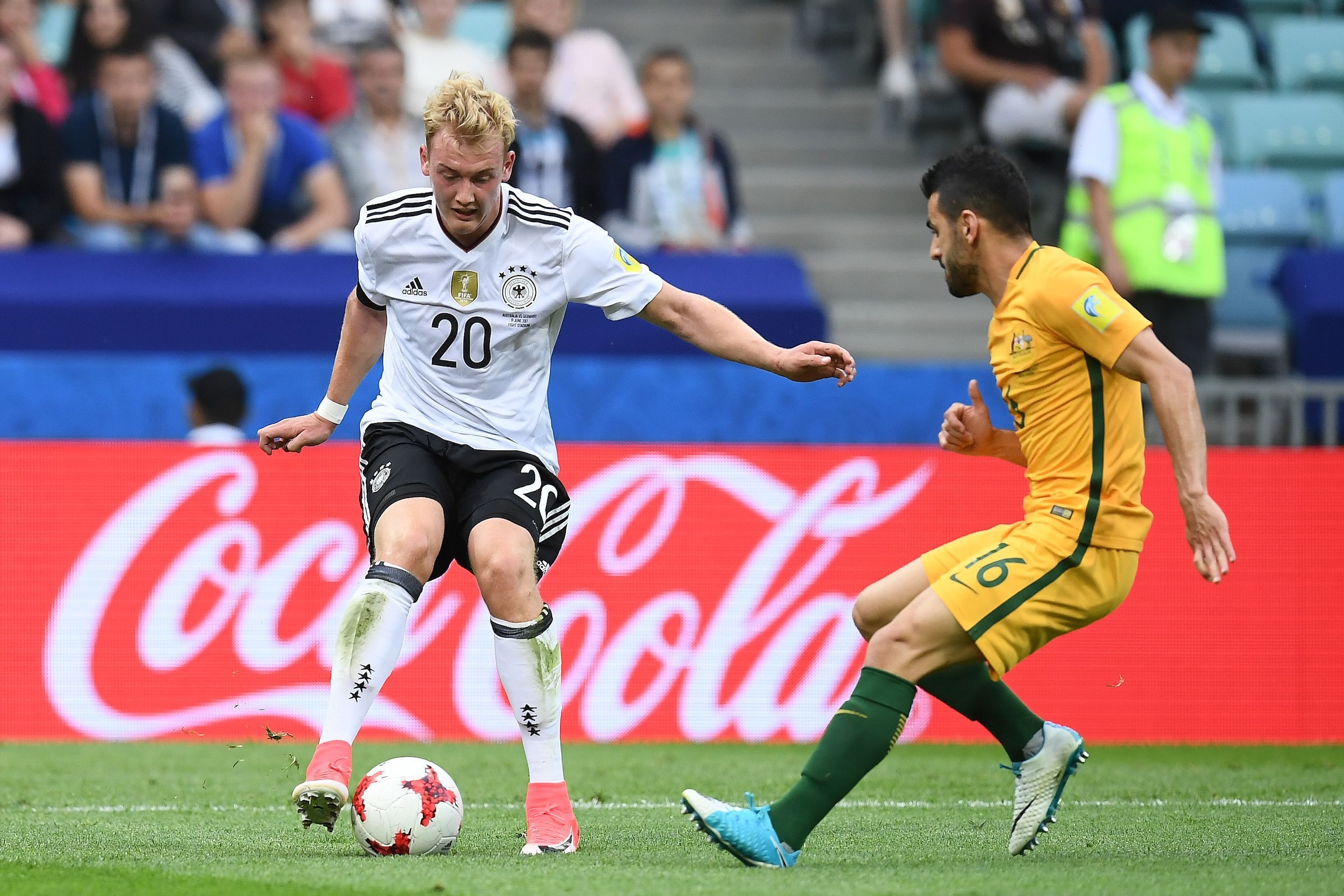 Germany's midfielder Julian Brandt plays the ball from Australia's defender Aziz Behich during the 2017 Confederations Cup group B football match between Australia and Germany at the Fisht Stadium in Sochi on June 19, 2017. / AFP PHOTO / FRANCK FIFE Germany's midfielder Julian Brandt plays the ball from Australia's defender Aziz Behich during the 2017 Confederations Cup group B football match between Australia and Germany at the Fisht Stadium in Sochi on June 19, 2017. / AFP PHOTO / FRANCK FIFE