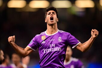 TOPSHOT - Real Madrid's Spanish midfielder Marco Asensio celebrates after scoring their fourth goal during the UEFA Champions League final football match between Juventus and Real Madrid at The Principality Stadium in Cardiff, south Wales, on June 3, 2017