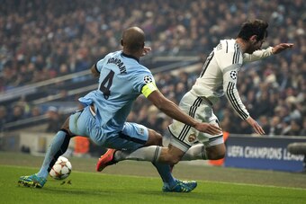 Manchester City's Belgian defender Vincent Kompany vies for the ball with CSKA Moscow's Russian midfielder Alan Dzagoev during the UEFA Champions League Group E football match between Manchester City and CSKA Moscow at the Etihad Stadium in Manchester Nor