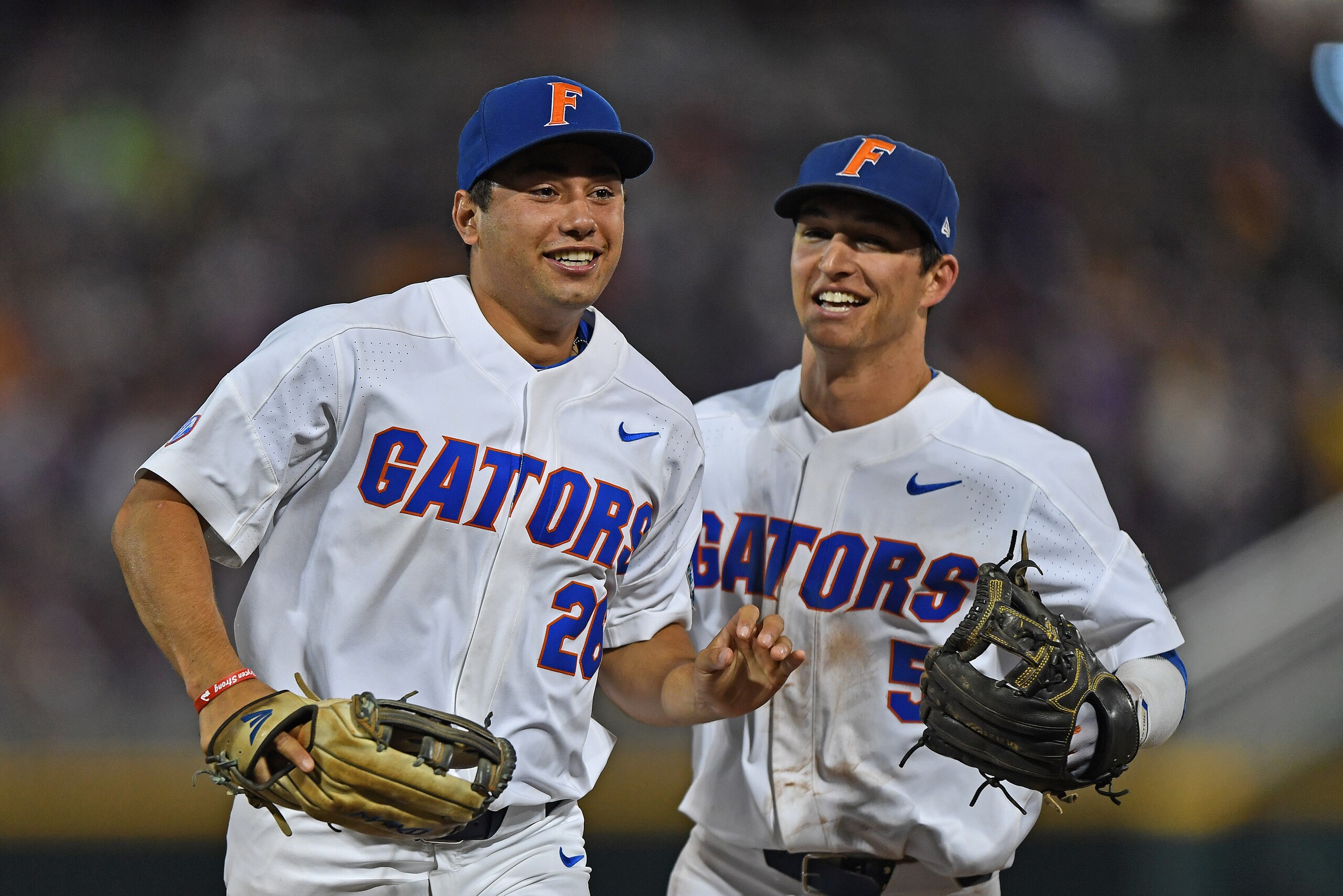 OMAHA, NE - JUNE 27:  Players Nick Horvath #26 and Dalton Guthrie #5 of the Florida Gators celebrate after getting the final out against the LSU Tigers in the eighth inning during game two of the College World Series Championship Series on June 27, 2017 a