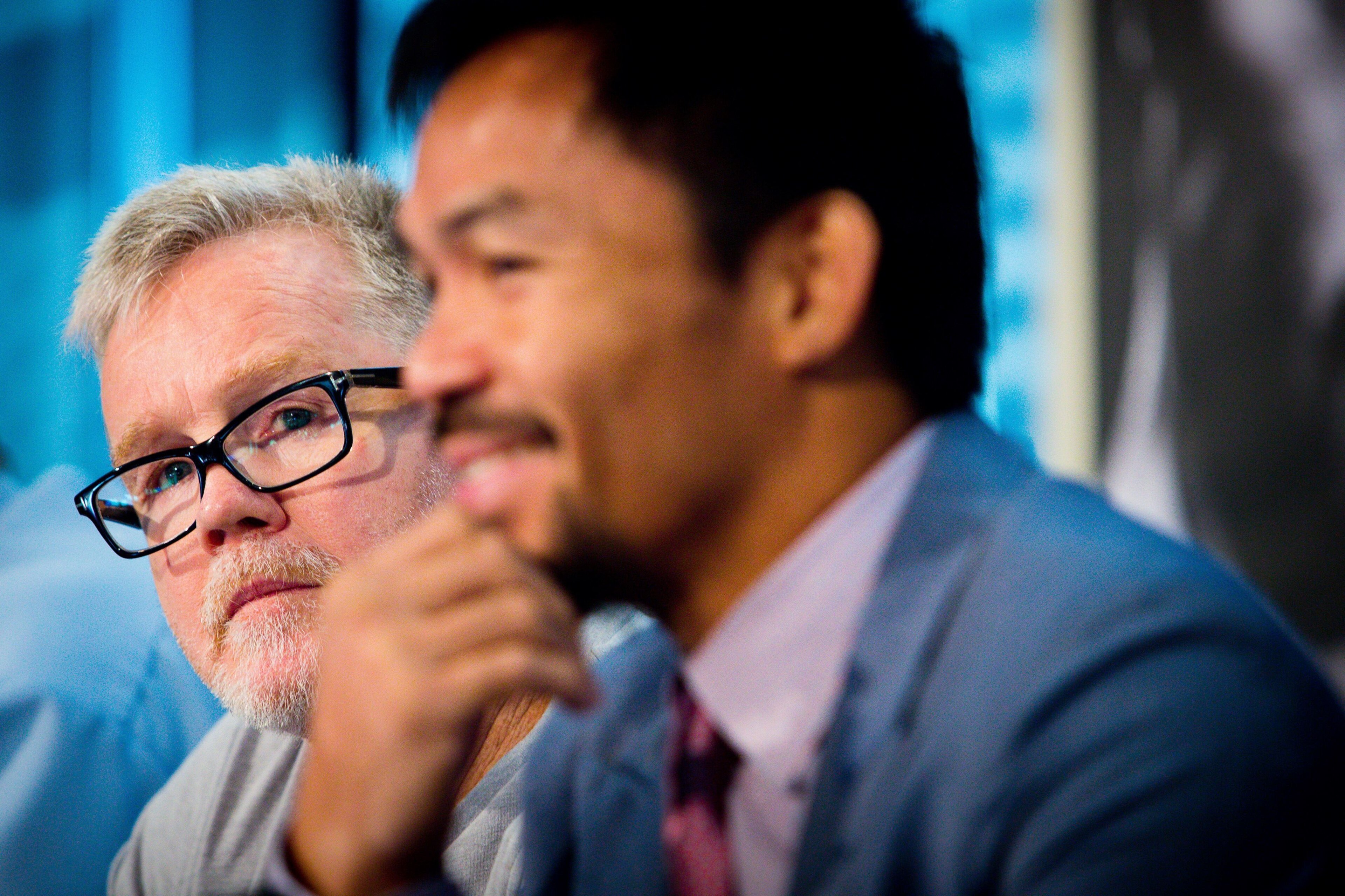Philippine boxer Manny Pacquiao (R) and trainer Freddie Roach attend a press conference to promote Pacquiao's WBO Welterweight title fight against Australian challenger Jeff Horn at Suncorp Stadium in Brisbane on June 28, 2017. 
Manny Pacquiao's world tit