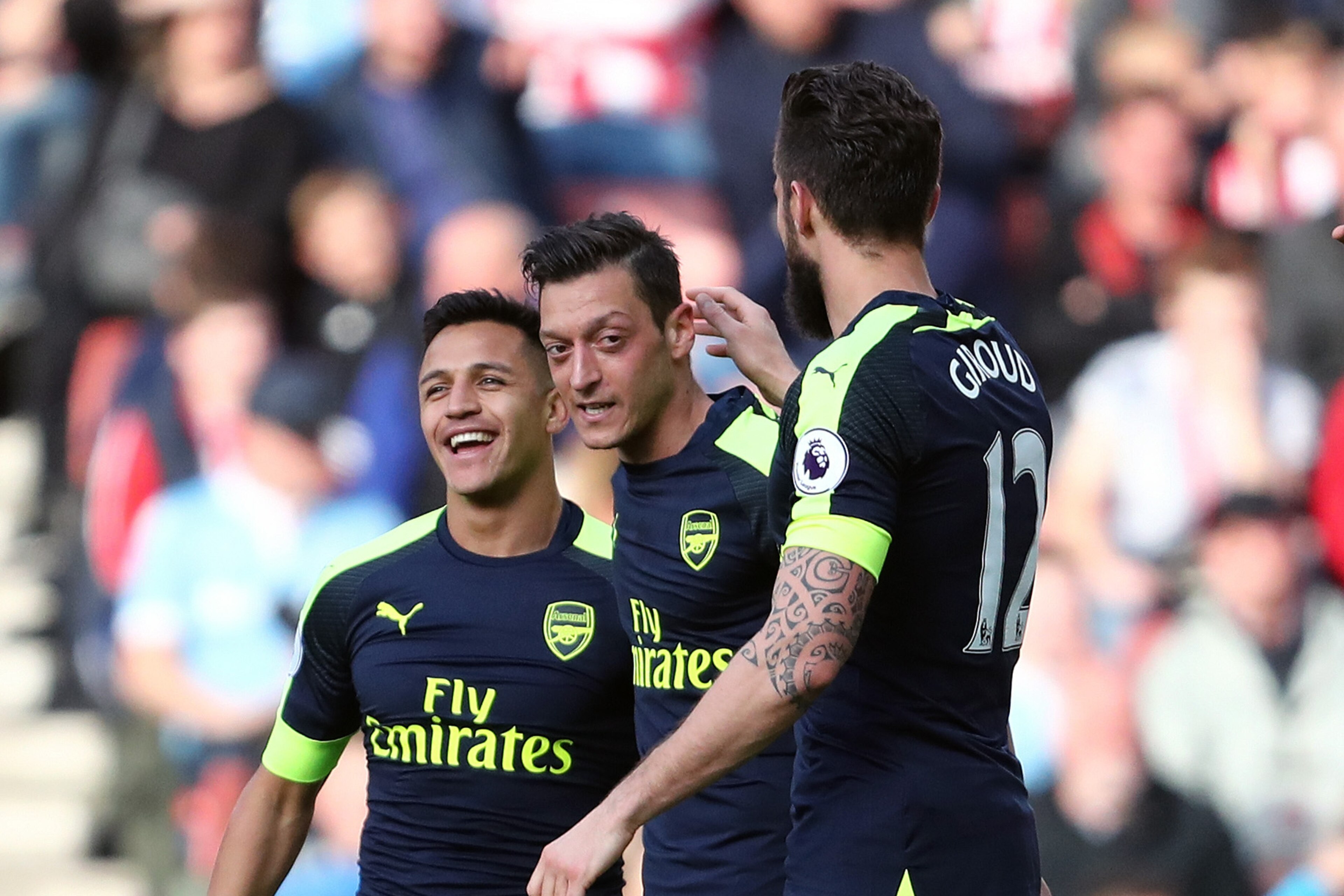 STOKE ON TRENT, ENGLAND - MAY 13: Mesut Ozil of Arsenal celebrates with Alexis Sanchez and Olivier Giroud of Arsenal after scoring a goal to make it 0-2 during the Premier League match between Stoke City and Arsenal at Bet365 Stadium on May 13, 2017 in St STOKE ON TRENT, ENGLAND - MAY 13: Mesut Ozil of Arsenal celebrates with Alexis Sanchez and Olivier Giroud of Arsenal after scoring a goal to make it 0-2 during the Premier League match between Stoke City and Arsenal at Bet365 Stadium on May 13, 2017 in St