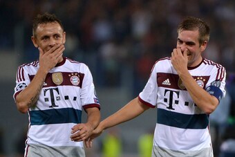Bayern Munich's defender Philipp Lahm (R) and Bayern Munich's Brazilian defender Rafinha celebrate after winning 1-7 the Champions League group stage football match AS Roma vs Bayern Munich on October 21, 2014 at the Olympic stadium in Rome.      AFP PHOT