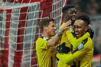 MUNICH, GERMANY - APRIL 26: Pierre-Emerick Aubameyang of Dortmund celebrates after scoring his team`s second goal with Ousmane Dembele of Dortmund during the German Cup (DFB Cup) semi final soccer match between FC Bayern Munich and Borussia Dortmund at th