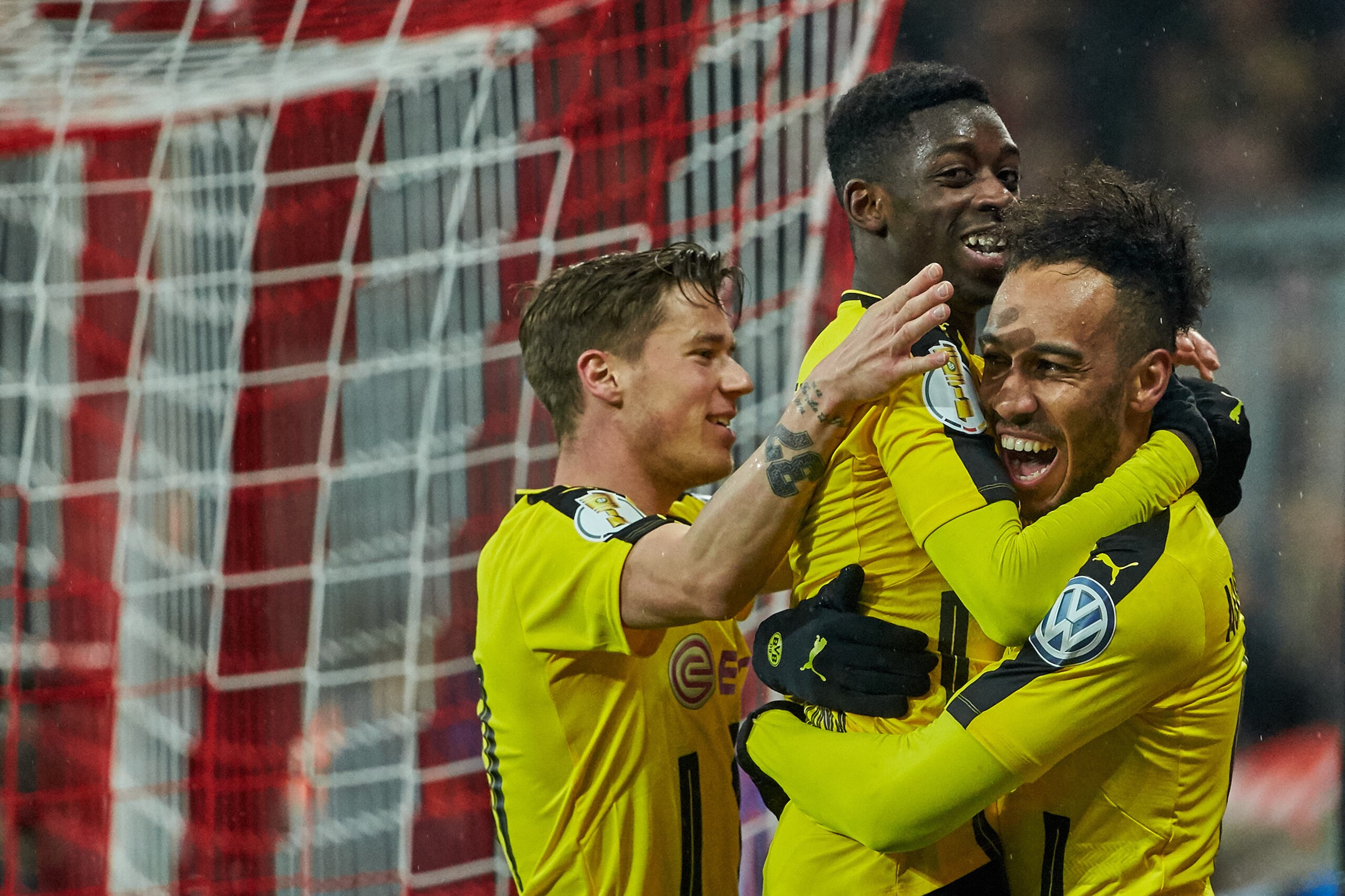 MUNICH, GERMANY - APRIL 26: Pierre-Emerick Aubameyang of Dortmund celebrates after scoring his team`s second goal with Ousmane Dembele of Dortmund during the German Cup (DFB Cup) semi final soccer match between FC Bayern Munich and Borussia Dortmund at th
