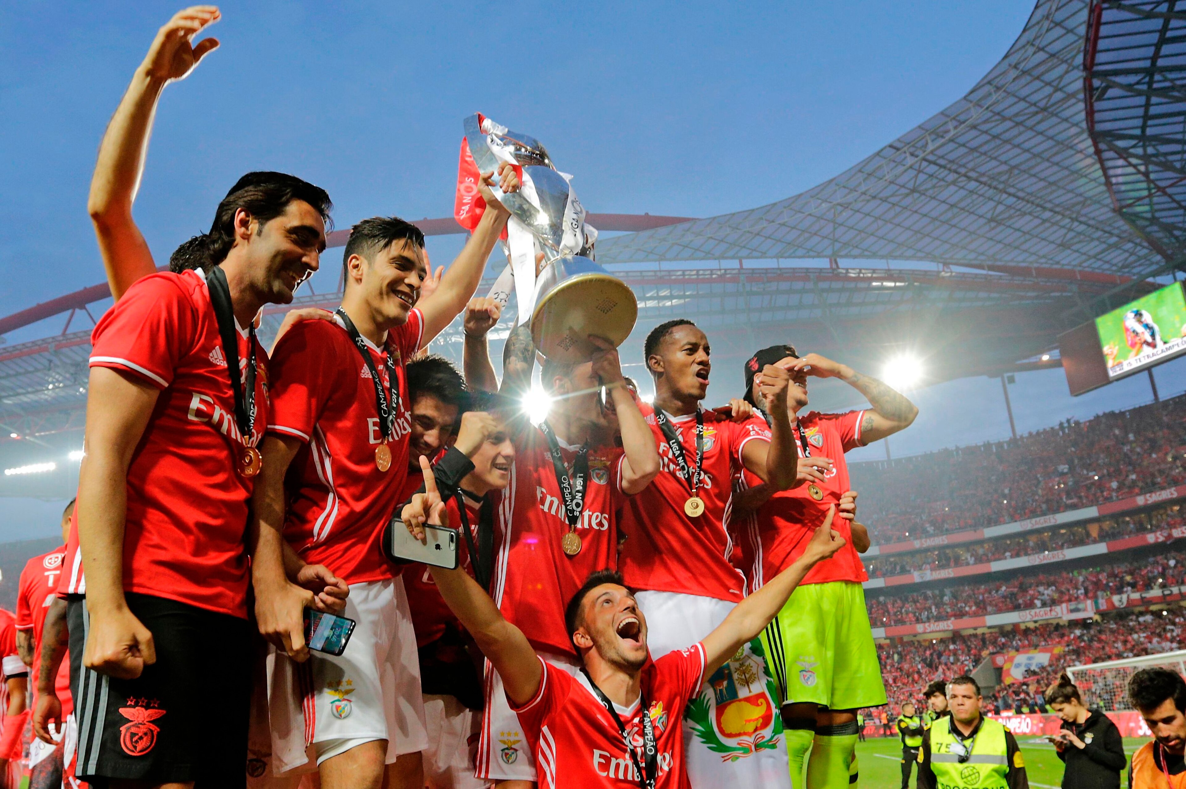 Benfica's players hold the cup after winning their 36th title at the end of the Portuguese league football match SL Benfica vs Vitoria Guimaraes SC at the Luz stadium in Lisbon on May 13, 2017.
Lisbon giants Benfica clinched a fourth straight Portuguese Benfica's players hold the cup after winning their 36th title at the end of the Portuguese league football match SL Benfica vs Vitoria Guimaraes SC at the Luz stadium in Lisbon on May 13, 2017.
Lisbon giants Benfica clinched a fourth straight Portuguese