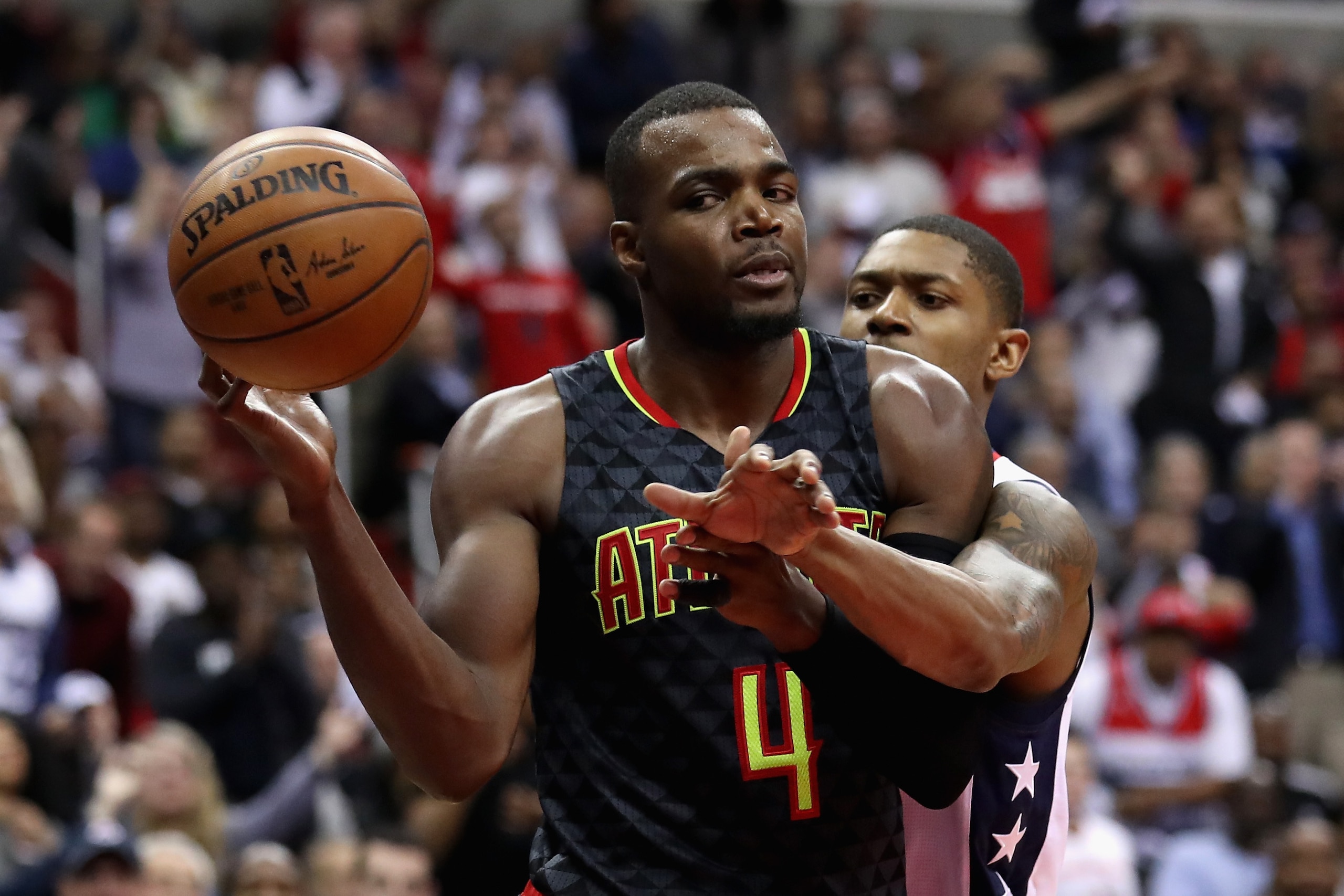 WASHINGTON, DC - APRIL 19: Paul Millsap #4 of the Atlanta Hawks passes the ball in front of Bradley Beal #3 of the Washington Wizards in the second half of Game Two of the Eastern Conference Quarterfinals during the 2017 NBA Playoffs at Verizon Center on 