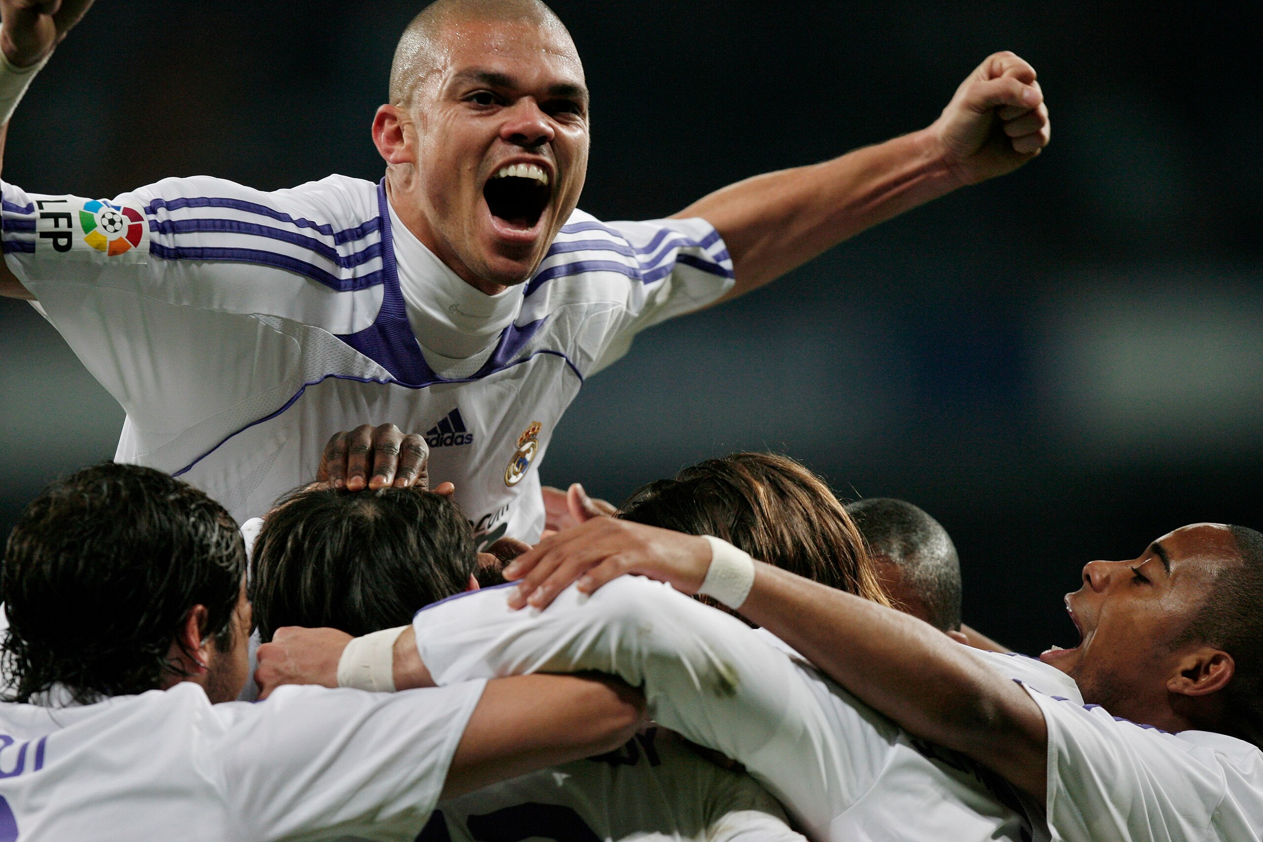 MADRID, SPAIN - DECEMBER 16:  Pepe (Top) of Real Madrid and Robinho (R) celebrate with their teammates after the opening goal by  Ruud van Nistelrooy during the La Liga match between Real Madrid and Osasuna at the Santiago Bernabeu Stadium on December 16,