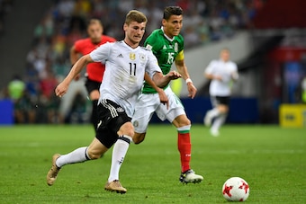 Germany's forward Timo Werner (L) fights for the ball with Mexico's defender Hector Moreno during the 2017 Confederations Cup semi-final football match between Germany and Mexico at the Fisht Stadium in Sochi on June 29, 2017. / AFP PHOTO / Alexander NEME