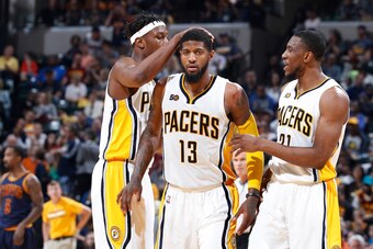 INDIANAPOLIS, IN - APRIL 23: Paul George #13 of the Indiana Pacers celebrates with Thaddeus Young #21 and Myles Turner #33 after scoring against the Cleveland Cavaliers in Game Four of the Eastern Conference Quarterfinals during the 2017 NBA Playoffs at B