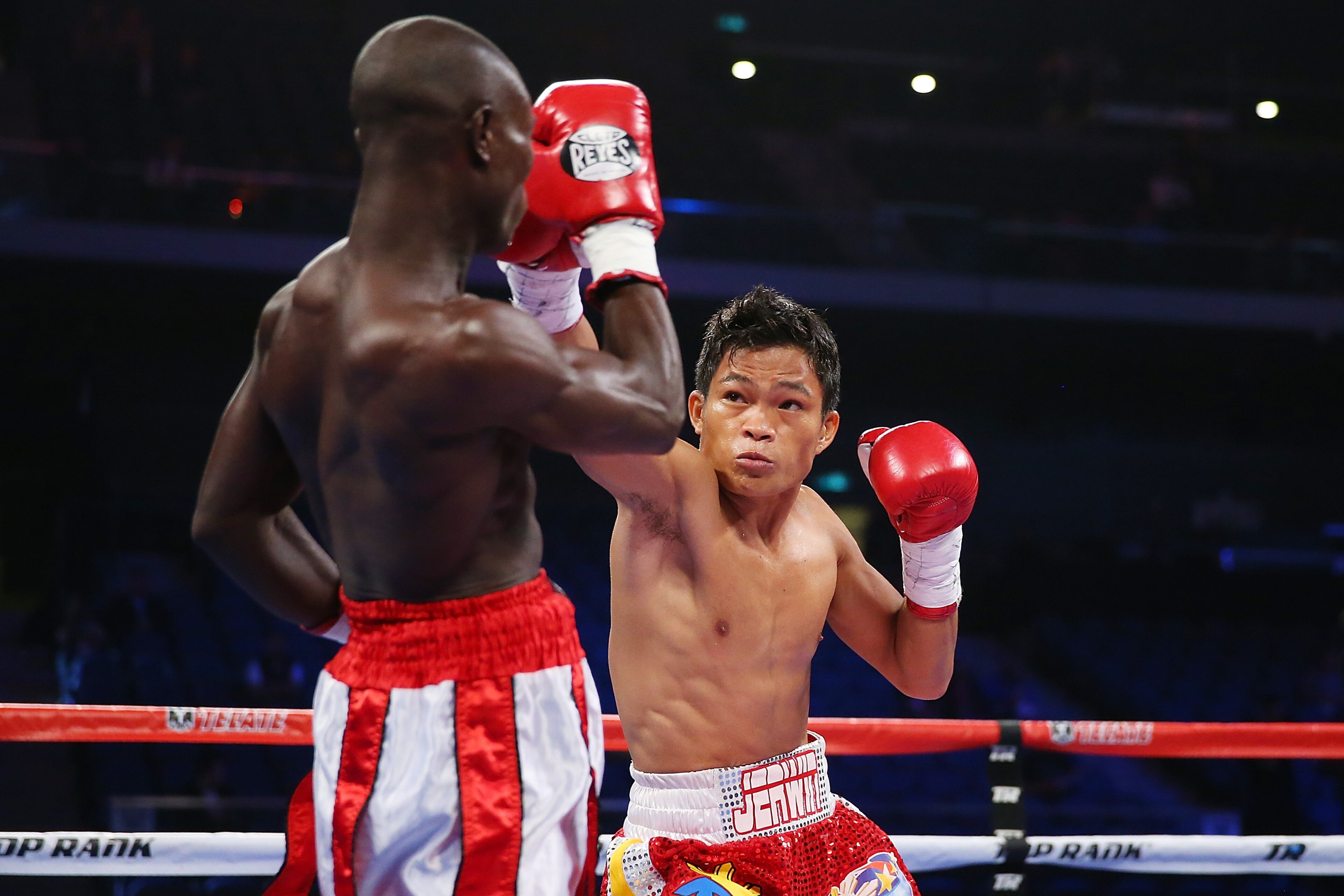 MACAU - NOVEMBER 23:  Jerwin Ancajas of the Philippines punches Fadhili Majiha of Tanzania during their bantamweight fight at The Venetian on November 23, 2014 in Macau, Macau  (Photo by Chris Hyde/Getty Images)