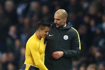 MANCHESTER, ENGLAND - DECEMBER 18:  Alexis Sanchez of Arsenal (L) and Josep Guardiola, Manager of Manchester City (R) embrace after the final whistle during the Premier League match between Manchester City and Arsenal at the Etihad Stadium on December 18,