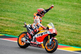 Spanish Honda rider Marc Marquez celebrates winning the MotoGP competition of the Moto Grand Prix of Germany at the Sachsenring Circuit on July 2, 2017 in Hohenstein-Ernstthal, eastern Germany.  / AFP PHOTO / ROBERT MICHAEL        (Photo credit should rea