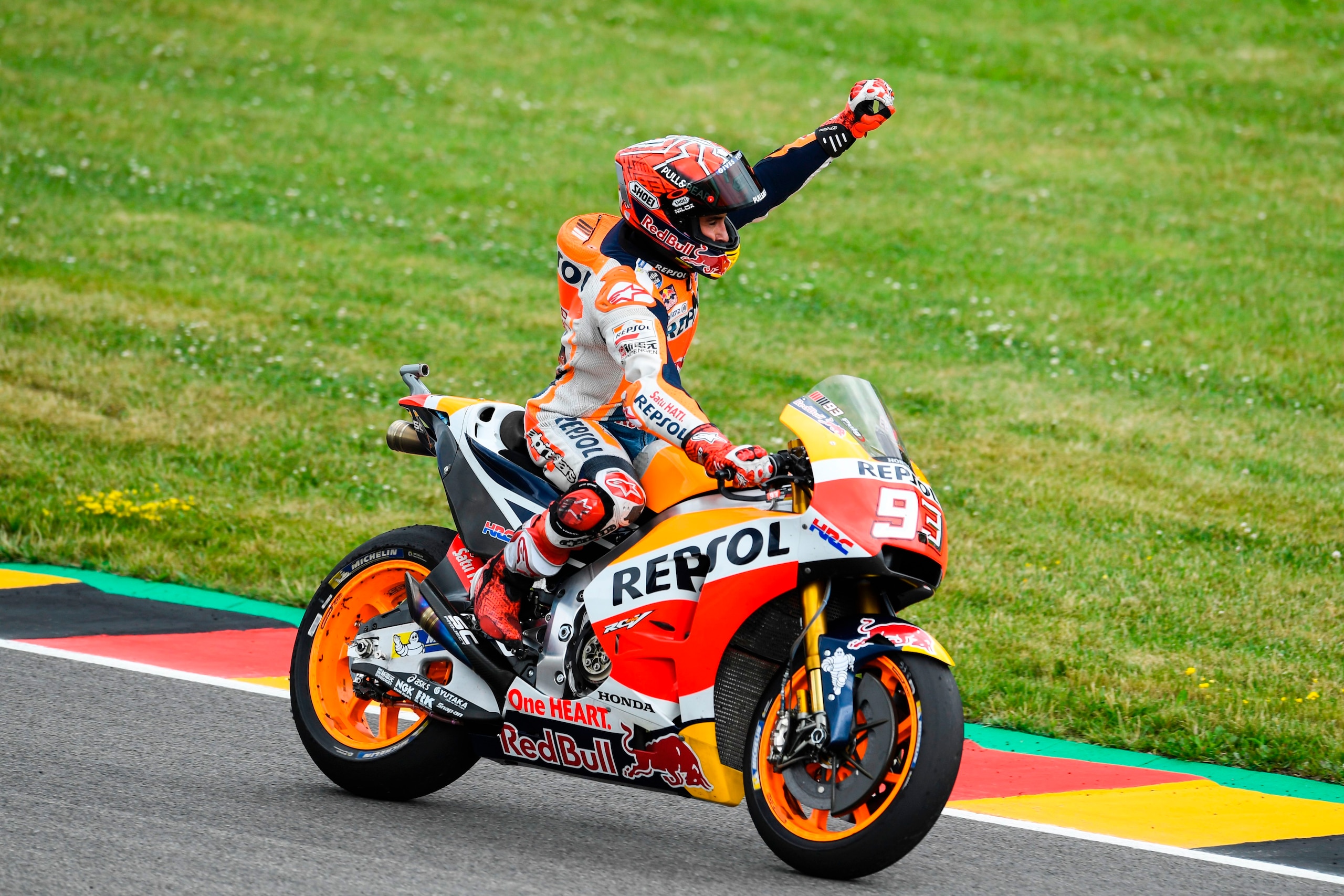 Spanish Honda rider Marc Marquez celebrates winning the MotoGP competition of the Moto Grand Prix of Germany at the Sachsenring Circuit on July 2, 2017 in Hohenstein-Ernstthal, eastern Germany.  / AFP PHOTO / ROBERT MICHAEL        (Photo credit should rea