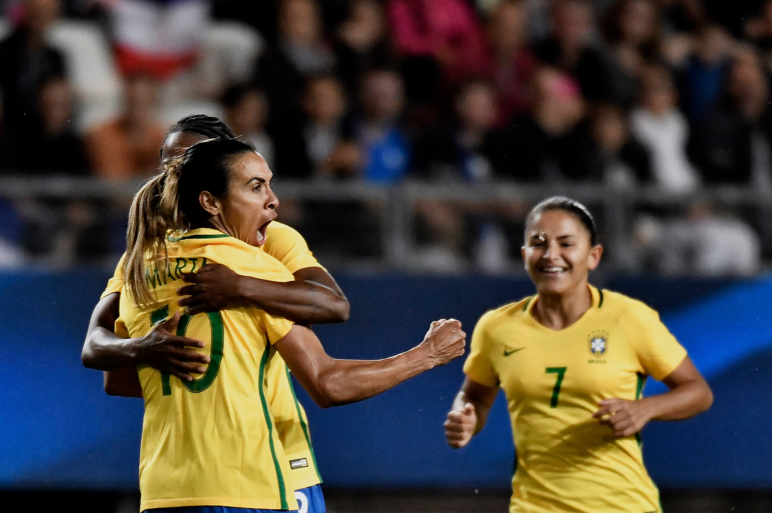 Brazil's midfielder Marta Silva (L) celebrates after scoring during the women's friendly football match between France and Brazil in Grenoble's Stade des Alpes on September 16, 2016. / AFP / JEFF PACHOUD        (Photo credit should read JEFF PACHOUD/AFP/G