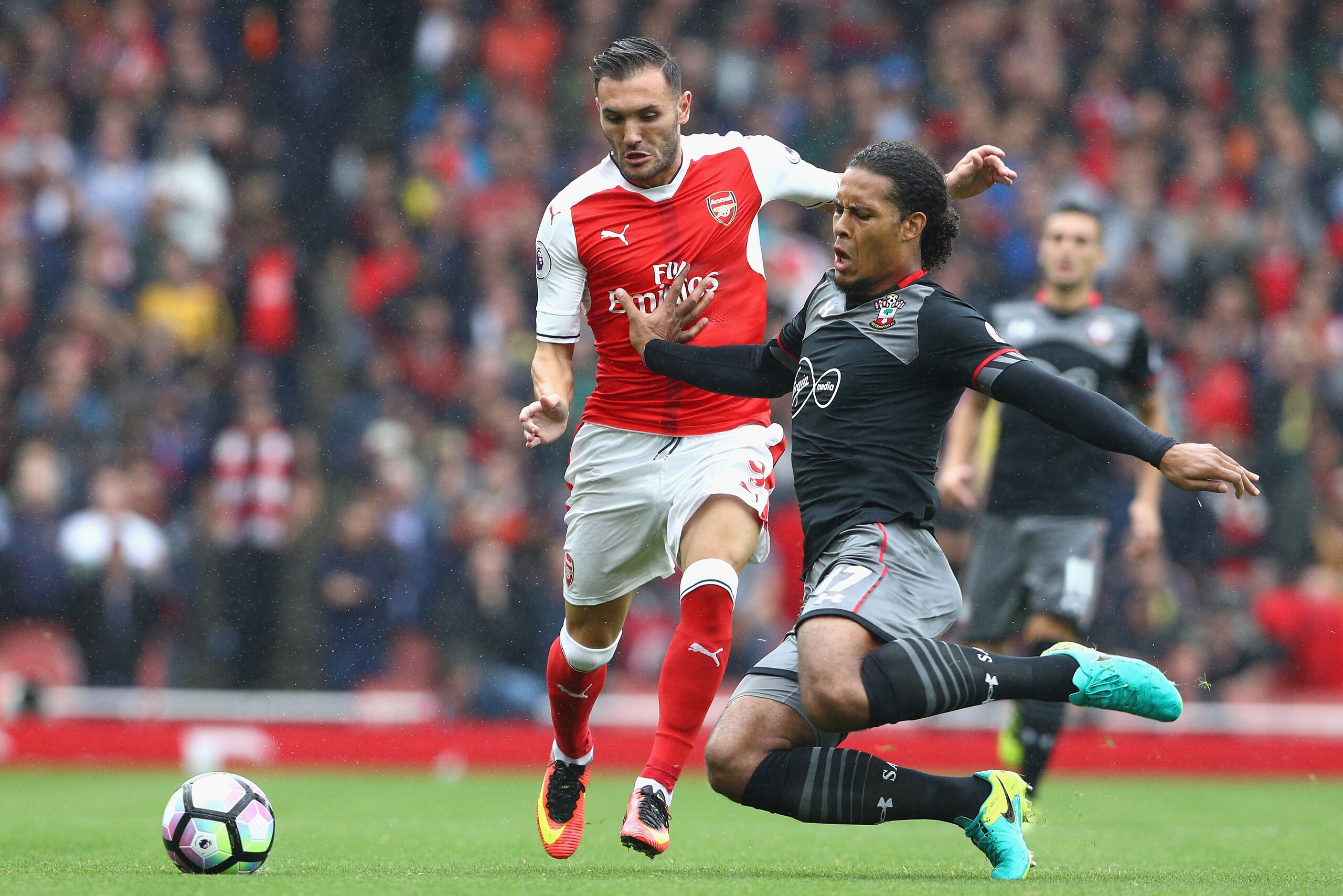 LONDON, ENGLAND - SEPTEMBER 10:  Virgil van Dijk of Southampton tackles Lucas Perez of Arsenal during the Premier League match between Arsenal and Southampton at Emirates Stadium on September 10, 2016 in London, England.  (Photo by Paul Gilham/Getty Image