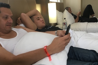 Aaron (center) and his father, Anthony, relax in the hotel room Thursday.