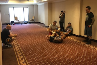 Bob Cook (left) and Eddie Bravo (right) watch a pre-fight Pico sparring session.