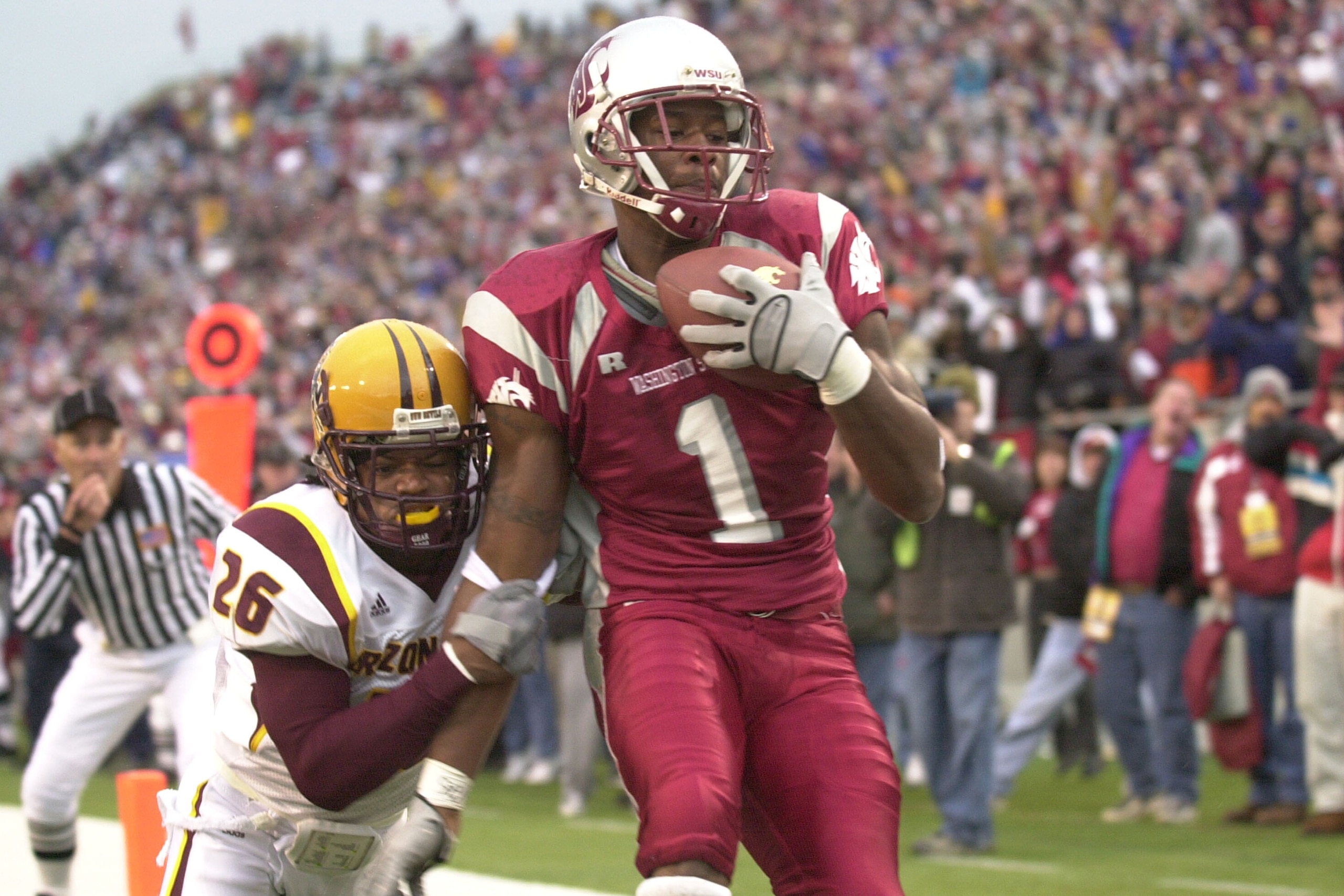 PULLMAN, WA - NOVEMBER 15:  Wide receiver Devard Darling #1 of the Washington State University Cougars scores a touchdown against R. J. Oliver #26 of the Arizona State Sun Devils on November 15, 2003 at Martin Stadium in Pullman, Washington.  (Photo by Ot