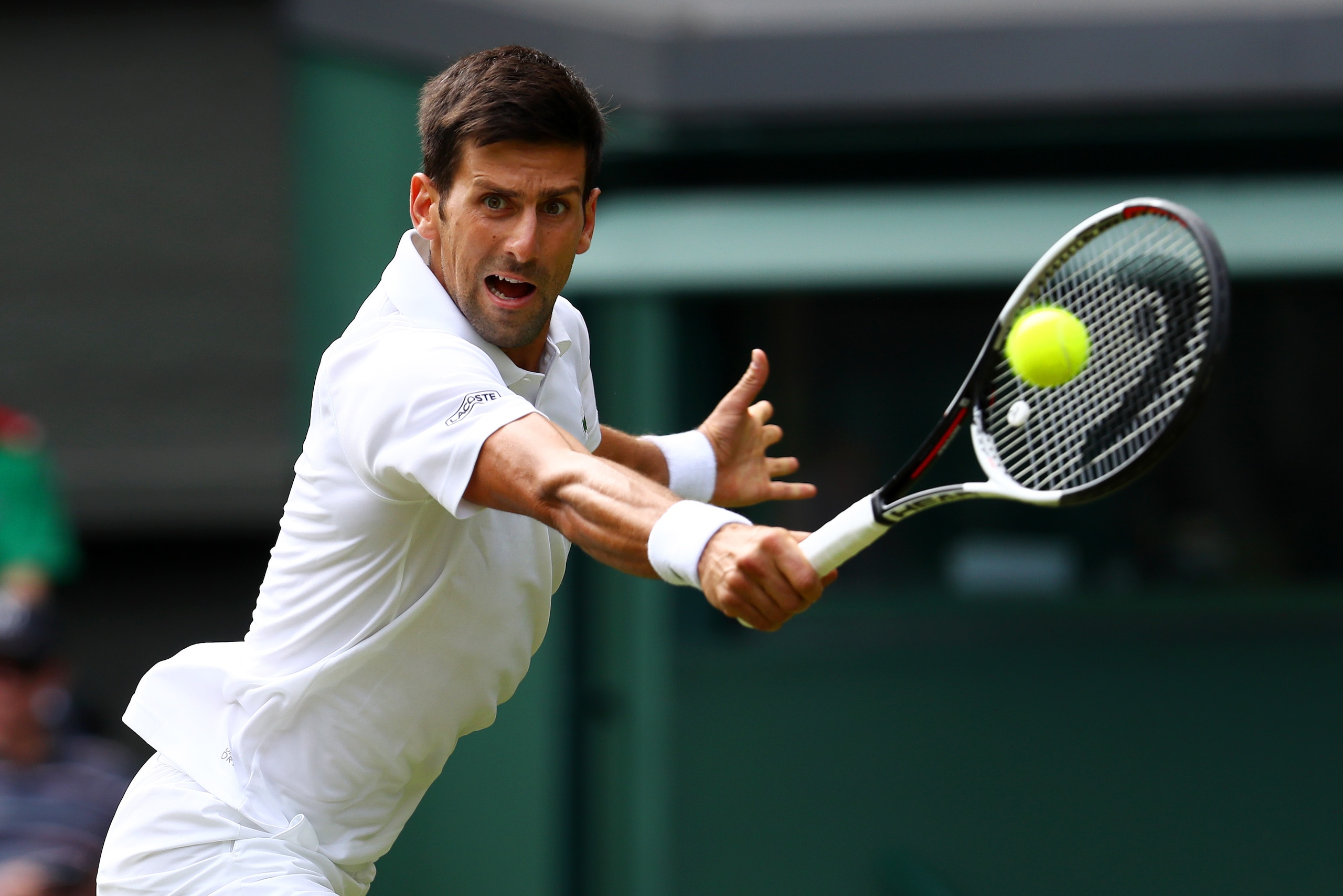 LONDON, ENGLAND - JULY 04: Novak Djokovic of Serbia plays a backhand during the Gentlemen's Singles first round match against Martin Klizan of Slovakia on day two of the Wimbledon Lawn Tennis Championships at the All England Lawn Tennis and Croquet Club LONDON, ENGLAND - JULY 04: Novak Djokovic of Serbia plays a backhand during the Gentlemen's Singles first round match against Martin Klizan of Slovakia on day two of the Wimbledon Lawn Tennis Championships at the All England Lawn Tennis and Croquet Club