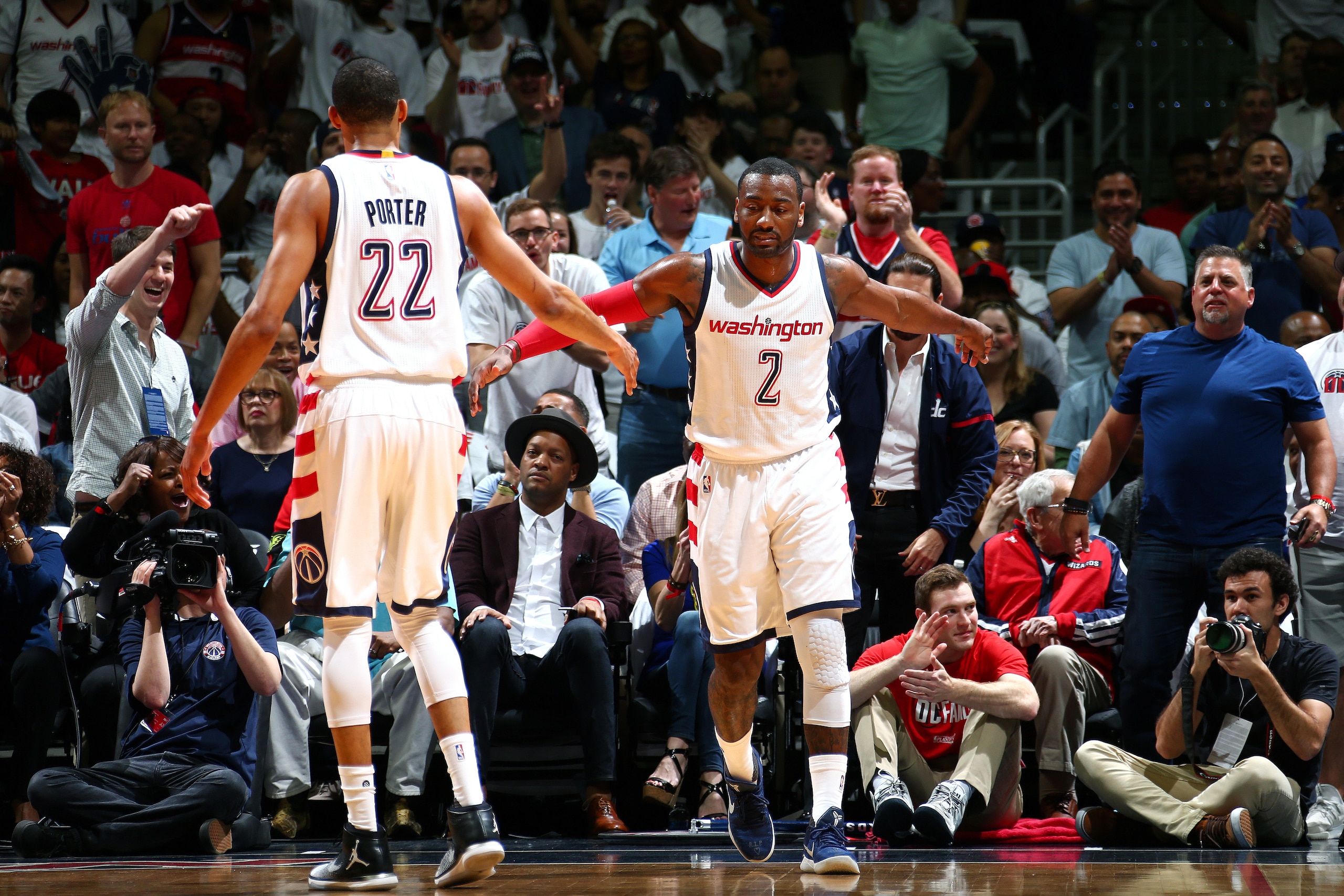 WASHINGTON, DC - APRIL 16: John Wall #2 and Otto Porter Jr. #22 of the Washington Wizards high five each other during the game against the Atlanta Hawks during the Eastern Conference Quarterfinals of the 2017 NBA Playoffs on April 16, 2017 at Verizon Cen WASHINGTON, DC - APRIL 16: John Wall #2 and Otto Porter Jr. #22 of the Washington Wizards high five each other during the game against the Atlanta Hawks during the Eastern Conference Quarterfinals of the 2017 NBA Playoffs on April 16, 2017 at Verizon Cen