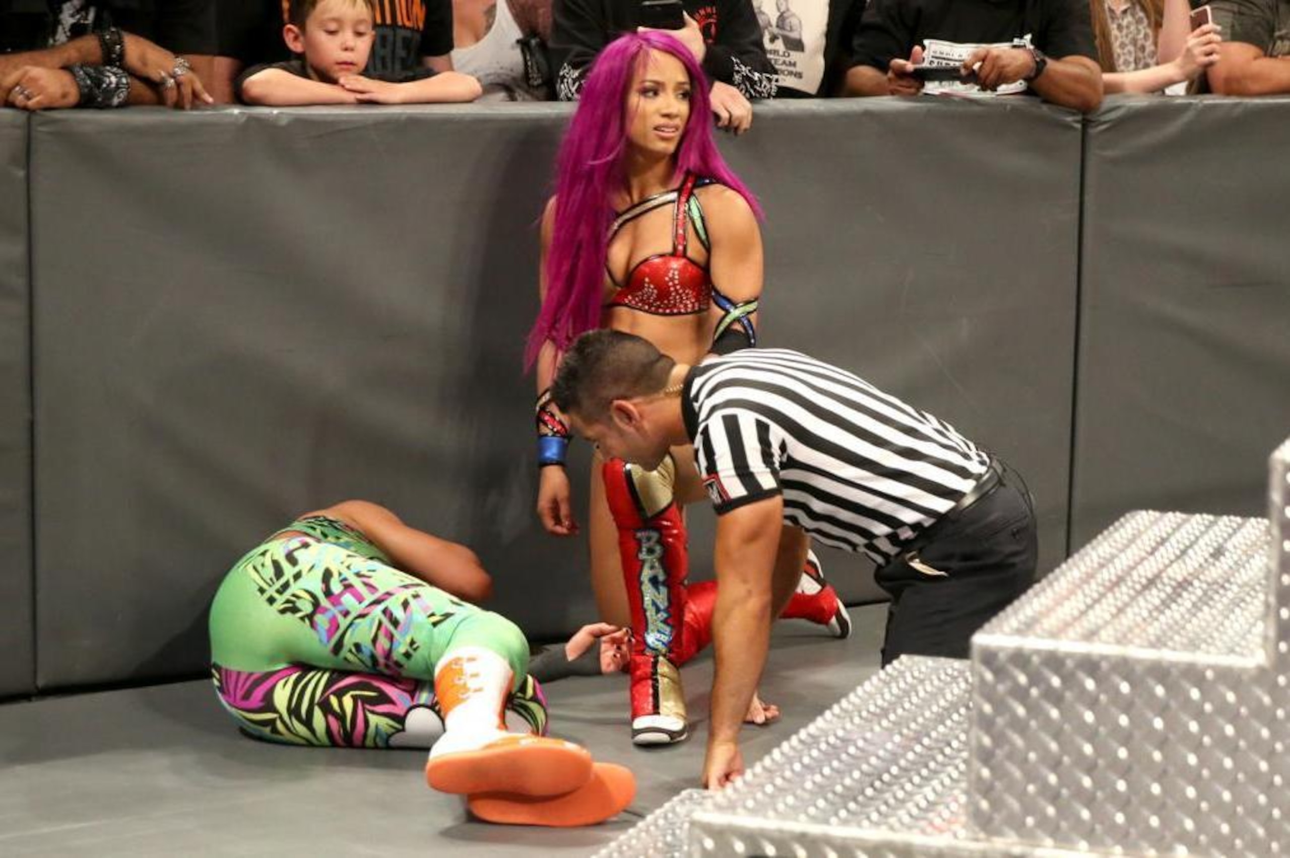 Bayley lies hurt at ringside on Raw. Bayley lies hurt at ringside on Raw.