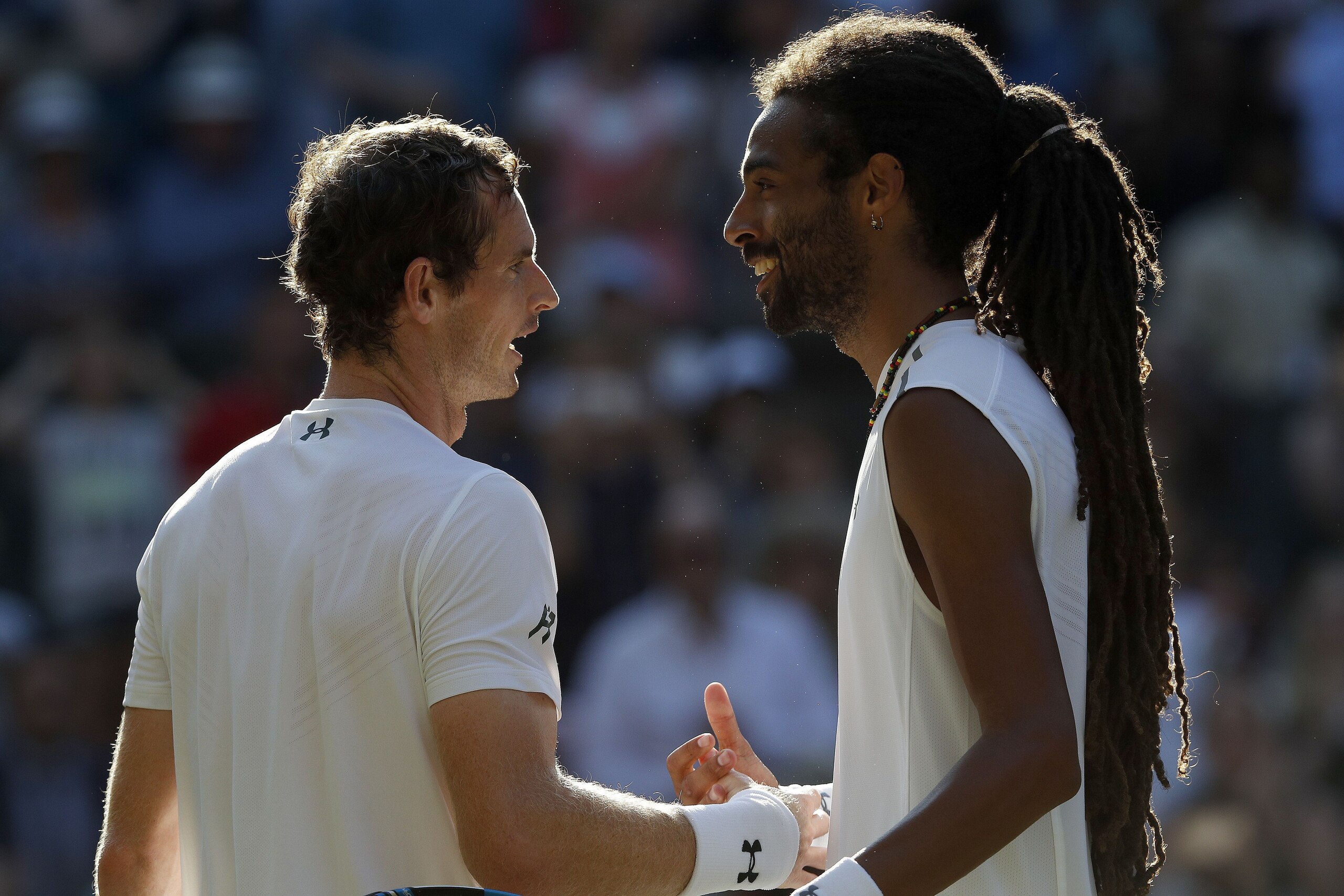 Britain's Andy Murray (L) shakes hands with Germany's Dustin Brown after winning their men's singles second round match on the third day of the 2017 Wimbledon Championships at The All England Lawn Tennis Club in Wimbledon, southwest London, on July 5, 201