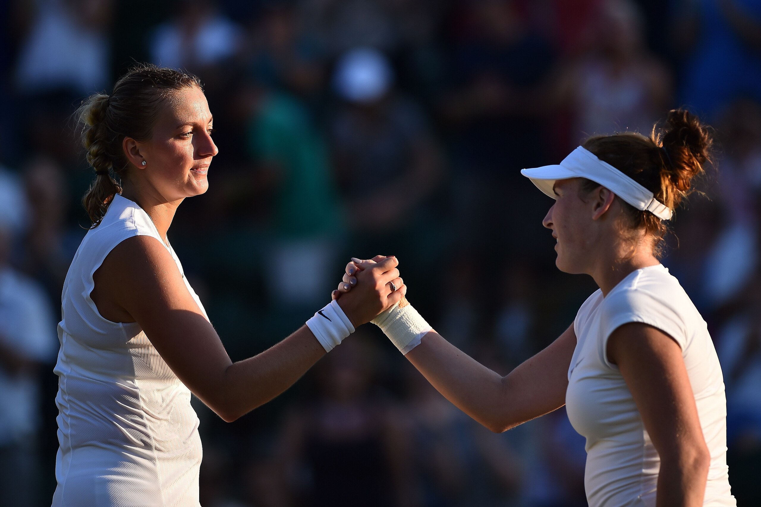 US player Madison Brengle (R) shakes hands with Czech Republic's Petra Kvitova after winning their women's singles second round match on the third day of the 2017 Wimbledon Championships at The All England Lawn Tennis Club in Wimbledon, southwest London, 