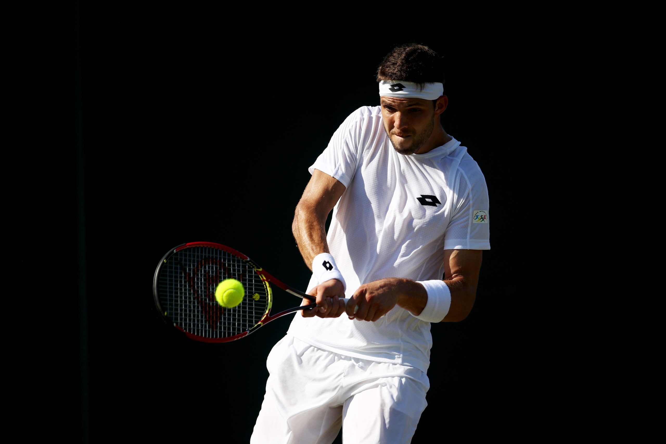 LONDON, ENGLAND - JULY 05:  Jiri Vesely of The Czech Republic plays a backhand during the Gentlemen's Singles second round match against Fabio Fognini of Italy on day three of the Wimbledon Lawn Tennis Championships at the All England Lawn Tennis and Croq