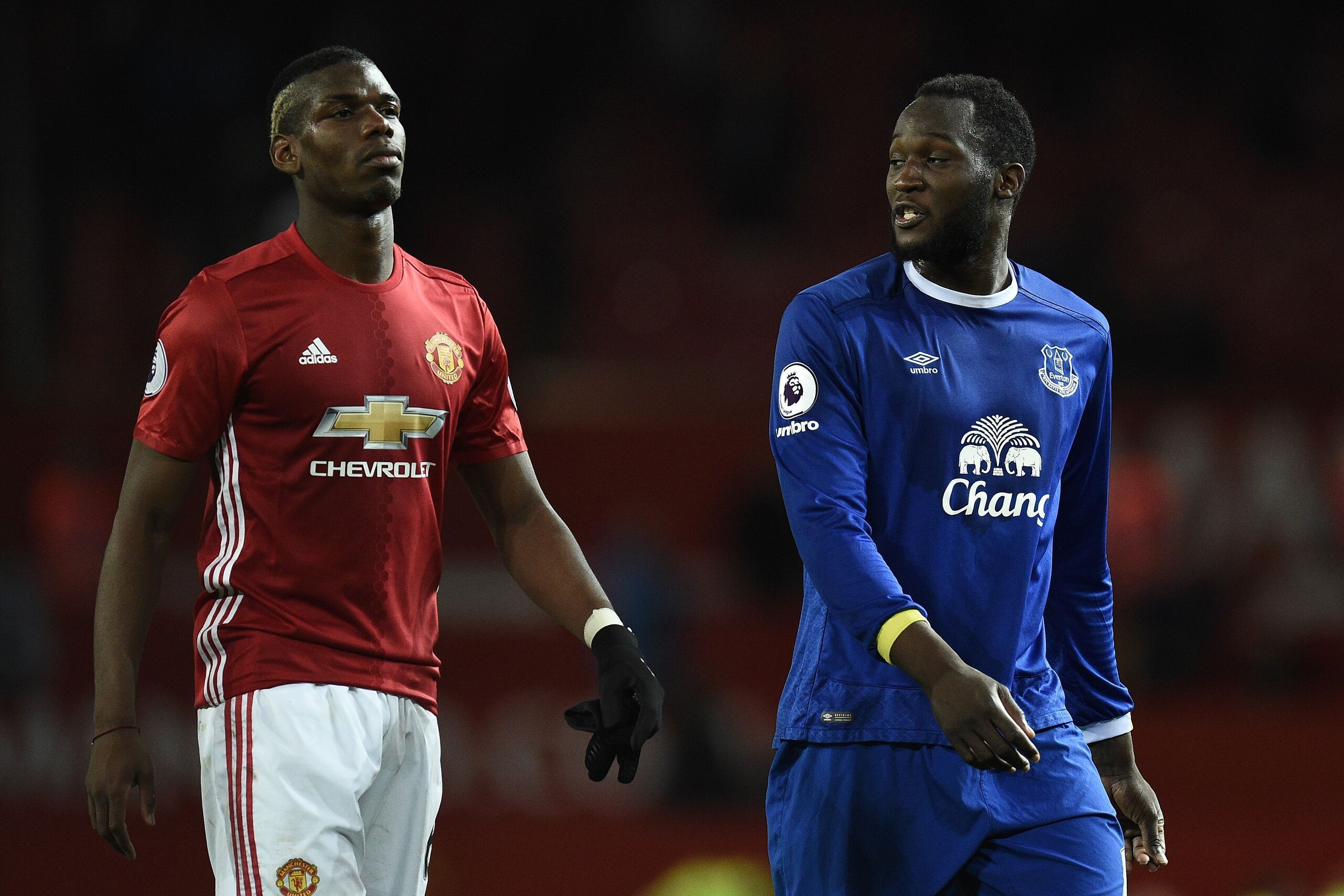 Manchester United's French midfielder Paul Pogba (L) and Everton's Belgian striker Romelu Lukaku leave the pitch following the English Premier League football match between Manchester United and Everton at Old Trafford in Manchester, north west England, o