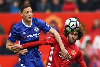 TOPSHOT - Chelsea's Serbian midfielder Nemanja Matic (L) vies with Manchester United's Belgian midfielder Marouane Fellaini during the English Premier League football match between Manchester United and Chelsea at Old Trafford in Manchester, north west En