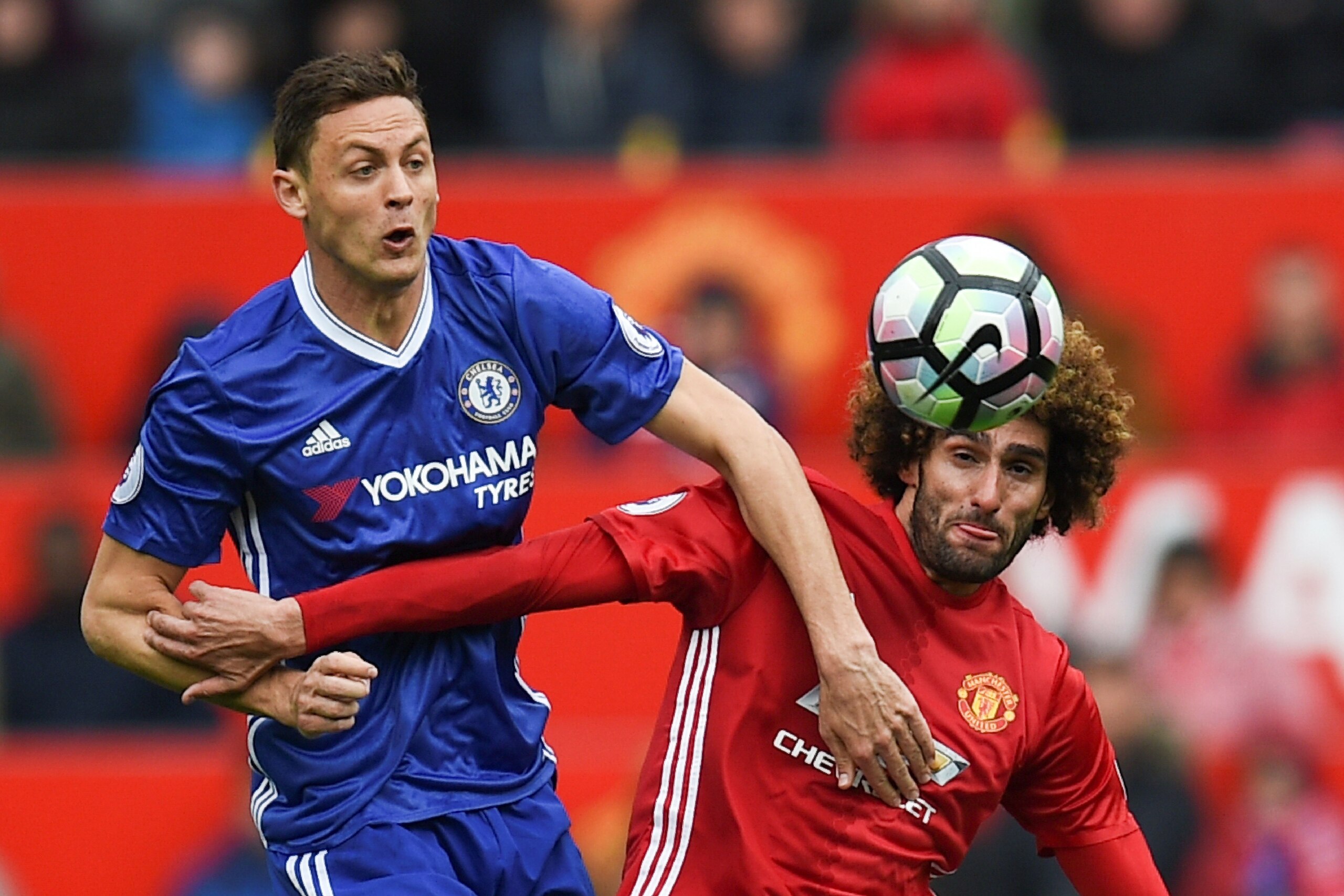 TOPSHOT - Chelsea's Serbian midfielder Nemanja Matic (L) vies with Manchester United's Belgian midfielder Marouane Fellaini during the English Premier League football match between Manchester United and Chelsea at Old Trafford in Manchester, north west En